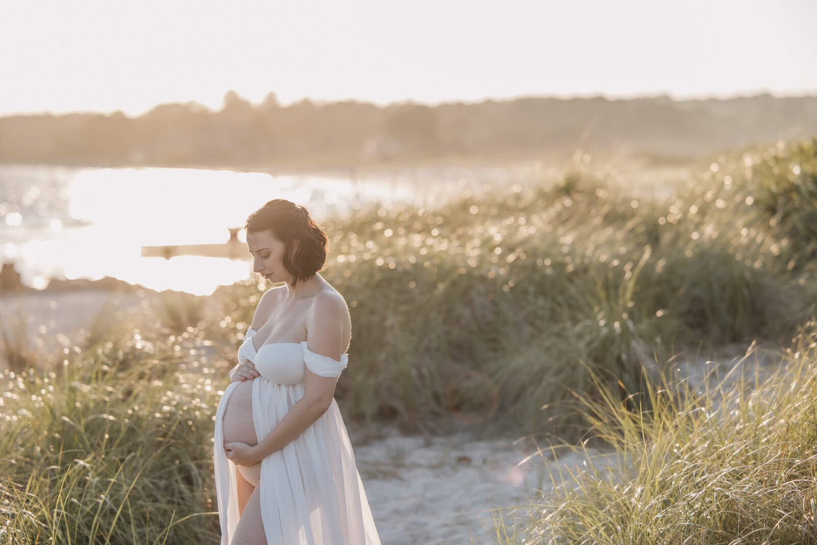Pregnant woman in glowy sunlight at Harkness Memorial State Park