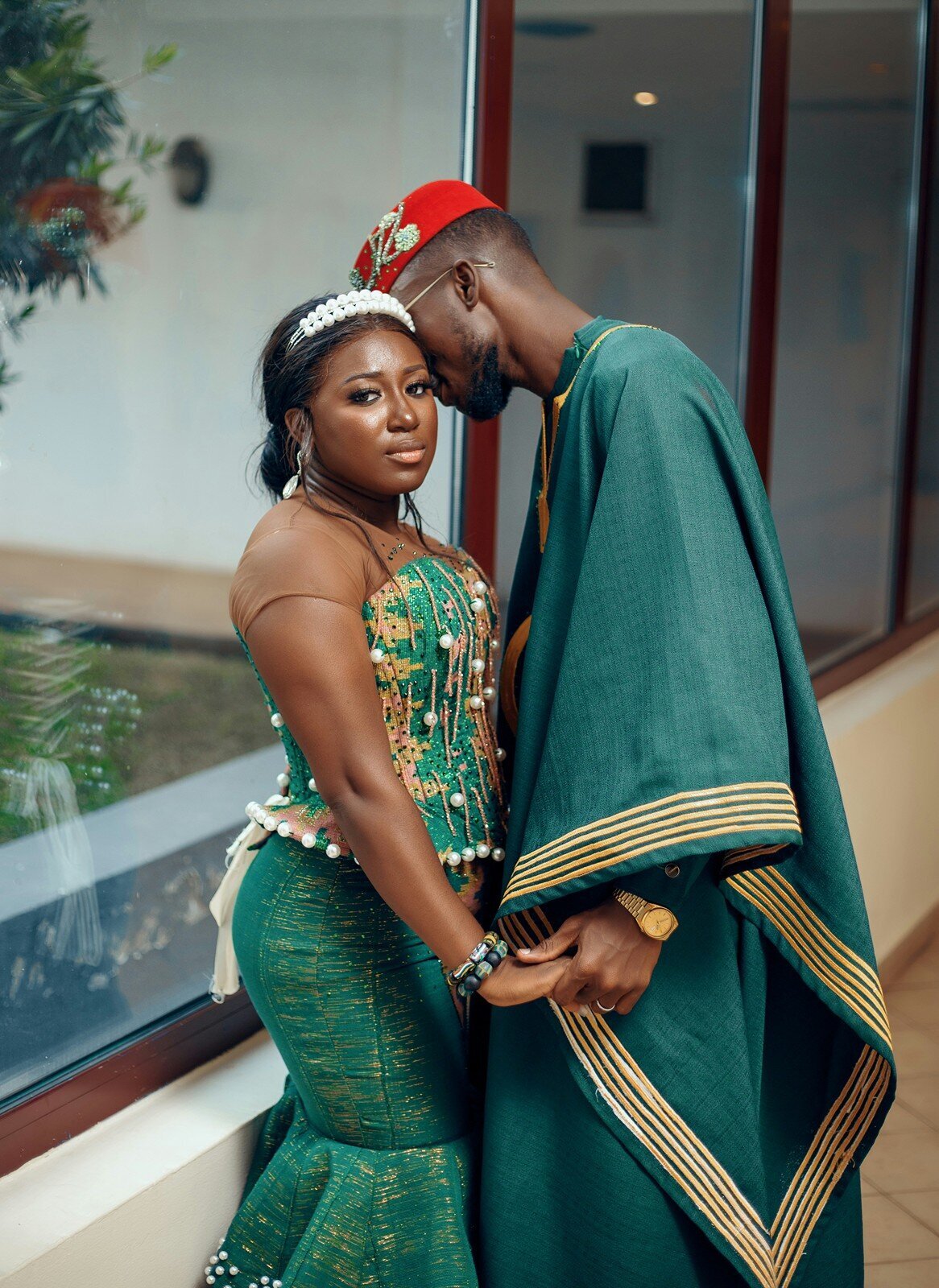 Couple in traditional African attire posing affectionately