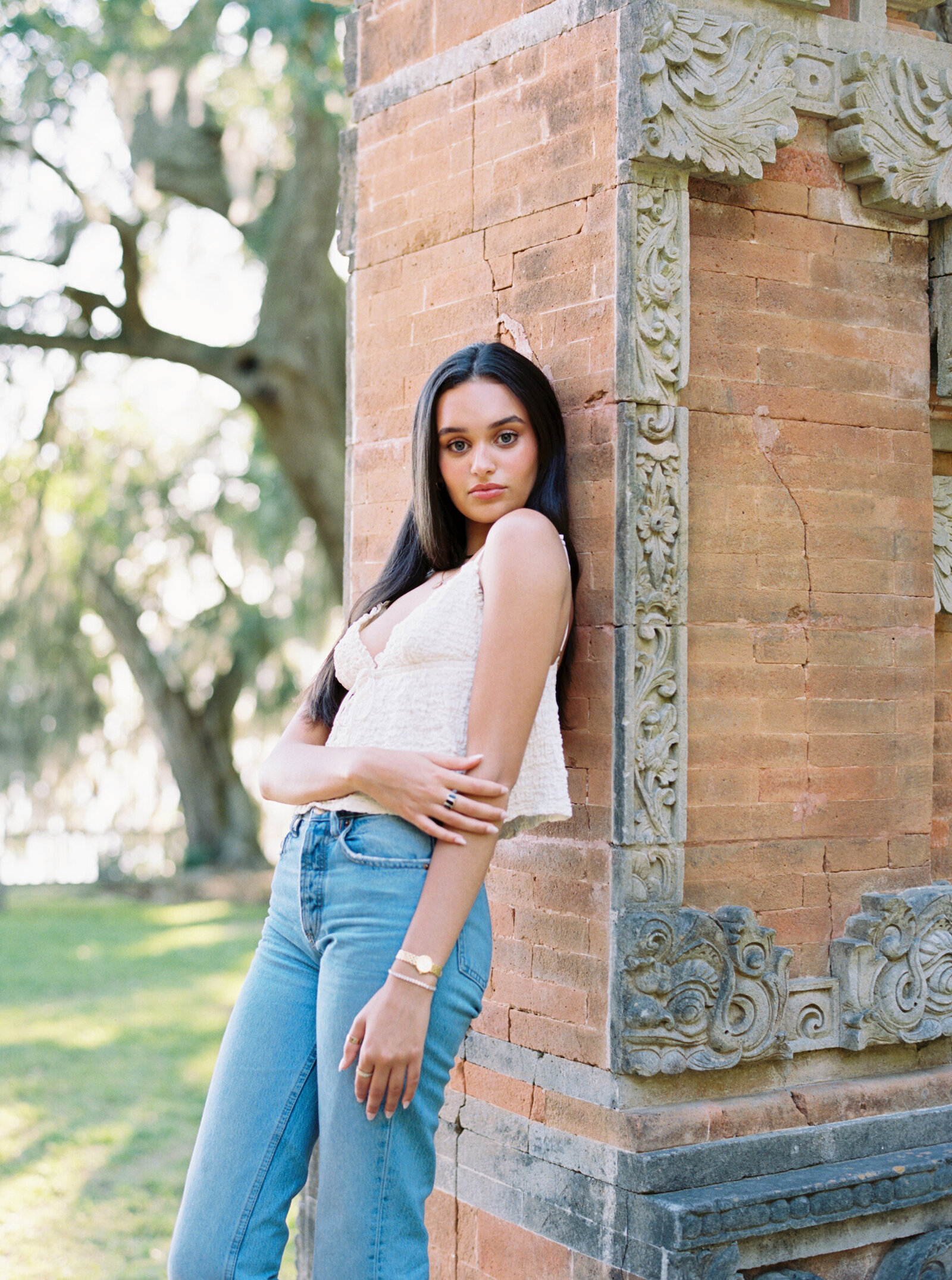 Senior portrait taken in the lush surroundings of Rip Van Winkle Gardens, captured on film by Morgan Alysse, Louisiana film photographer.
