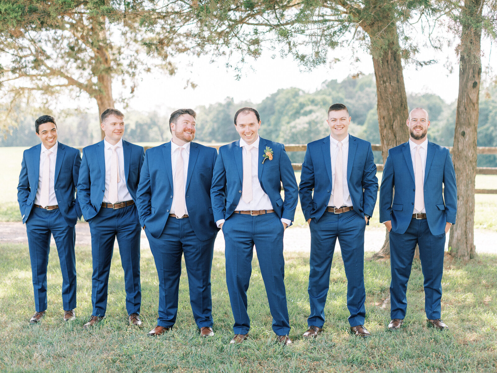 Groom stands with his groom party