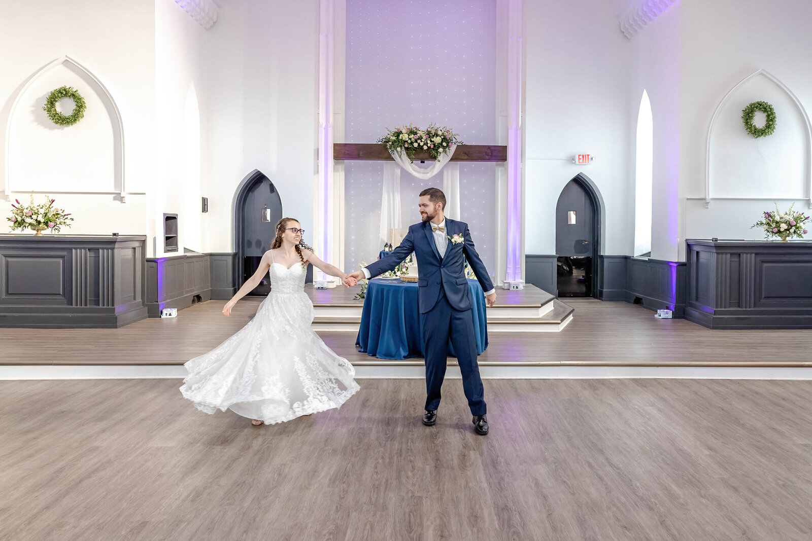 Bride and groom joyfully dancing together at their wedding reception, capturing their love and celebration in a beautifully decorated venue in Pennsylvania.