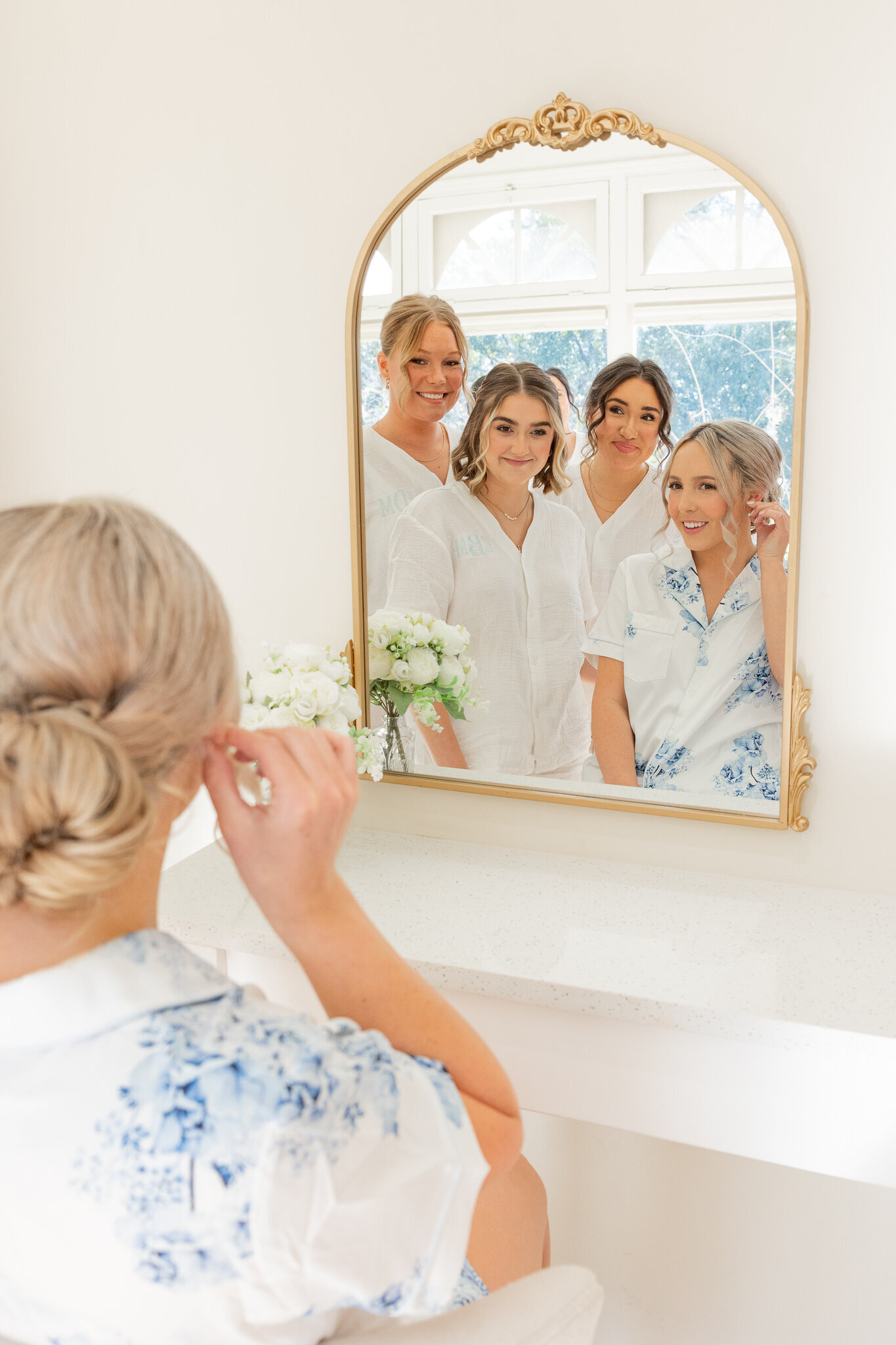 bride putting on earings