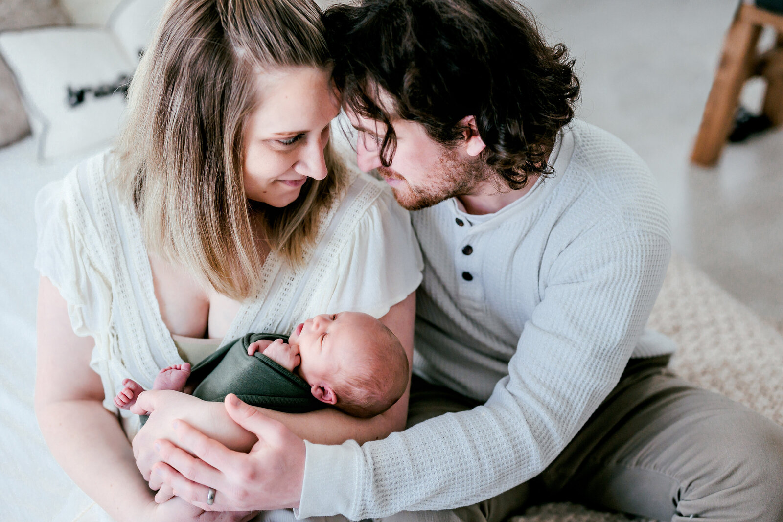 Mother holding her newborn baby boy while father nuzzles her face in ocean View, New Jersey