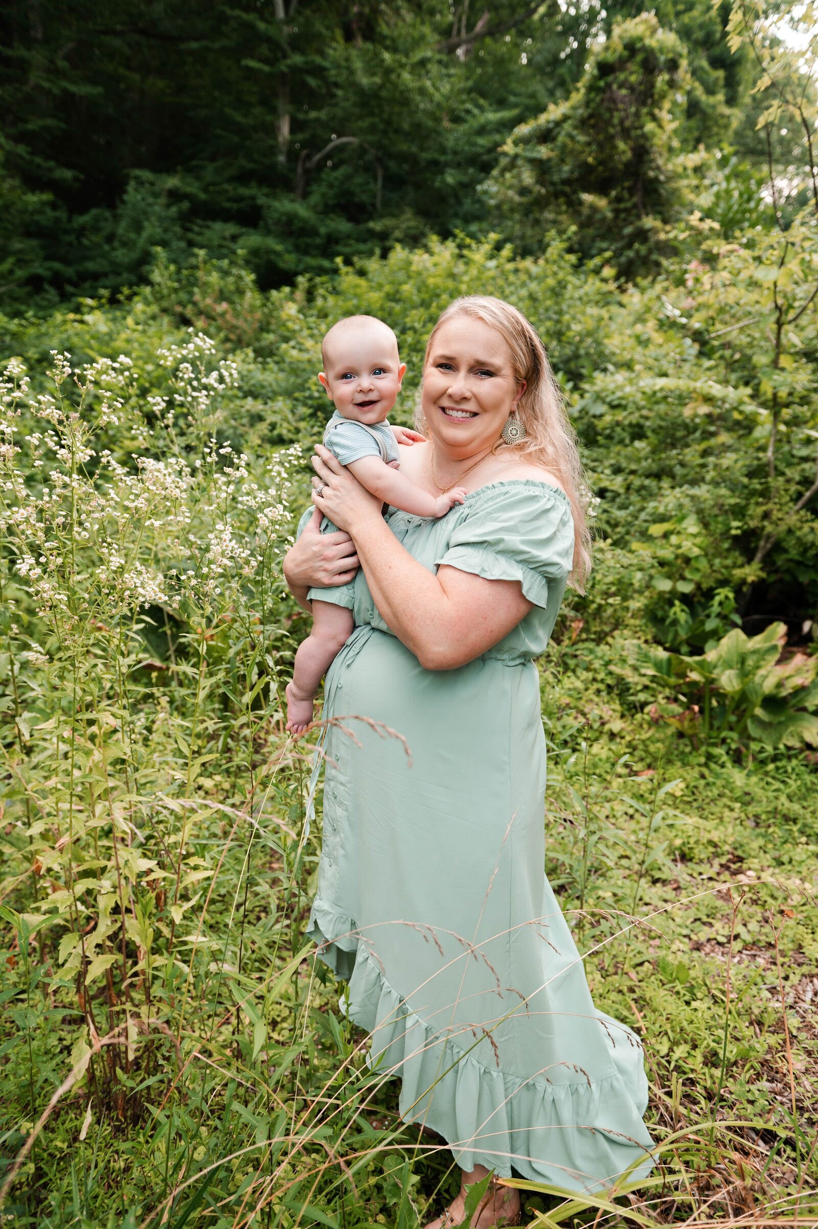 mom holding her smiling 6 month old son