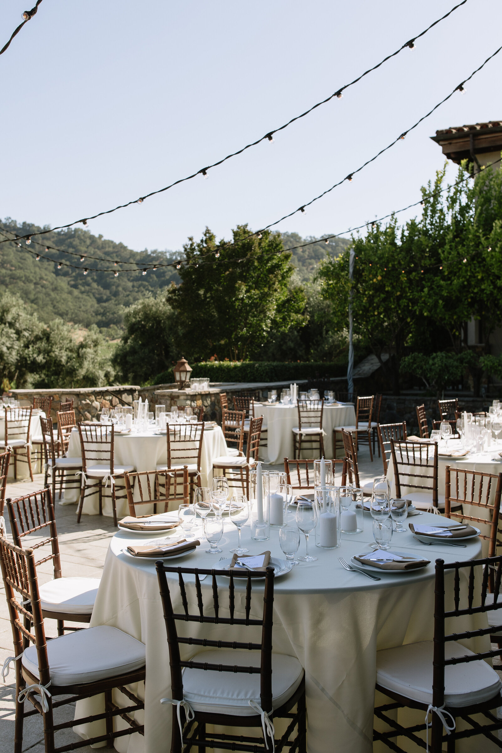 beautifully set tables with florals for outdoor reception