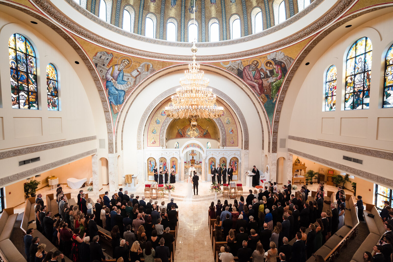 Wide angle photo of the wedding ceremony inside Annunciation Cathedral