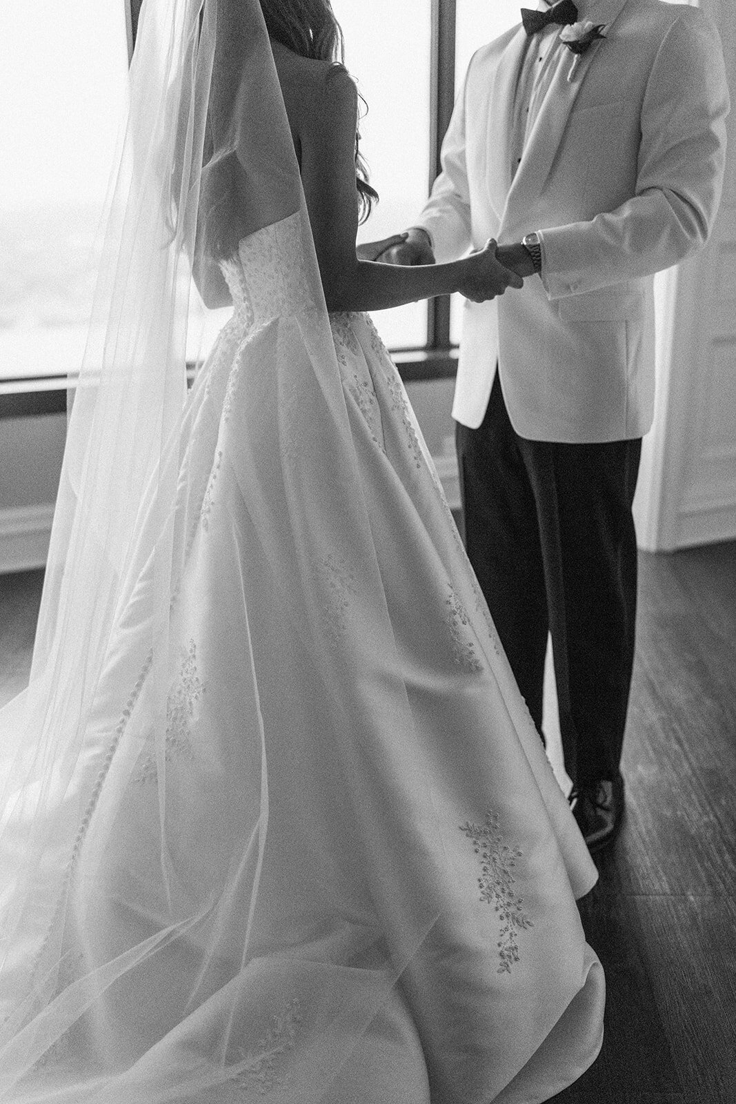 black and white portrait of bride and groom standing together