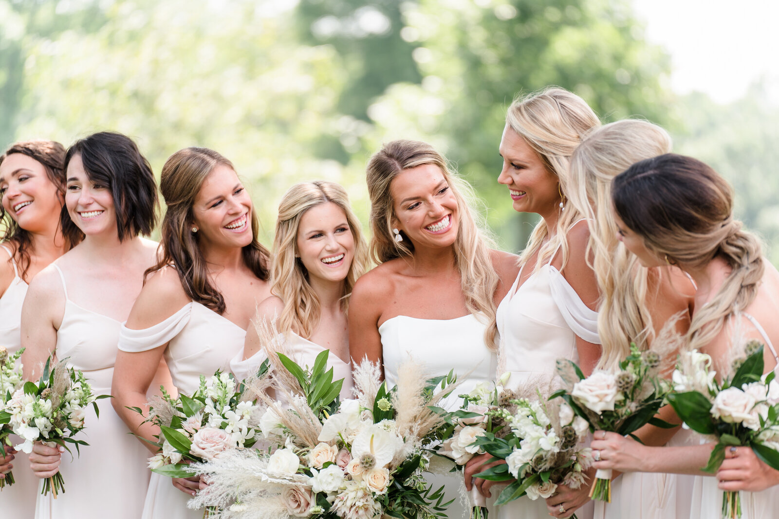 Bride smiles at her bridesmaids at the Franklin Park Conservatory