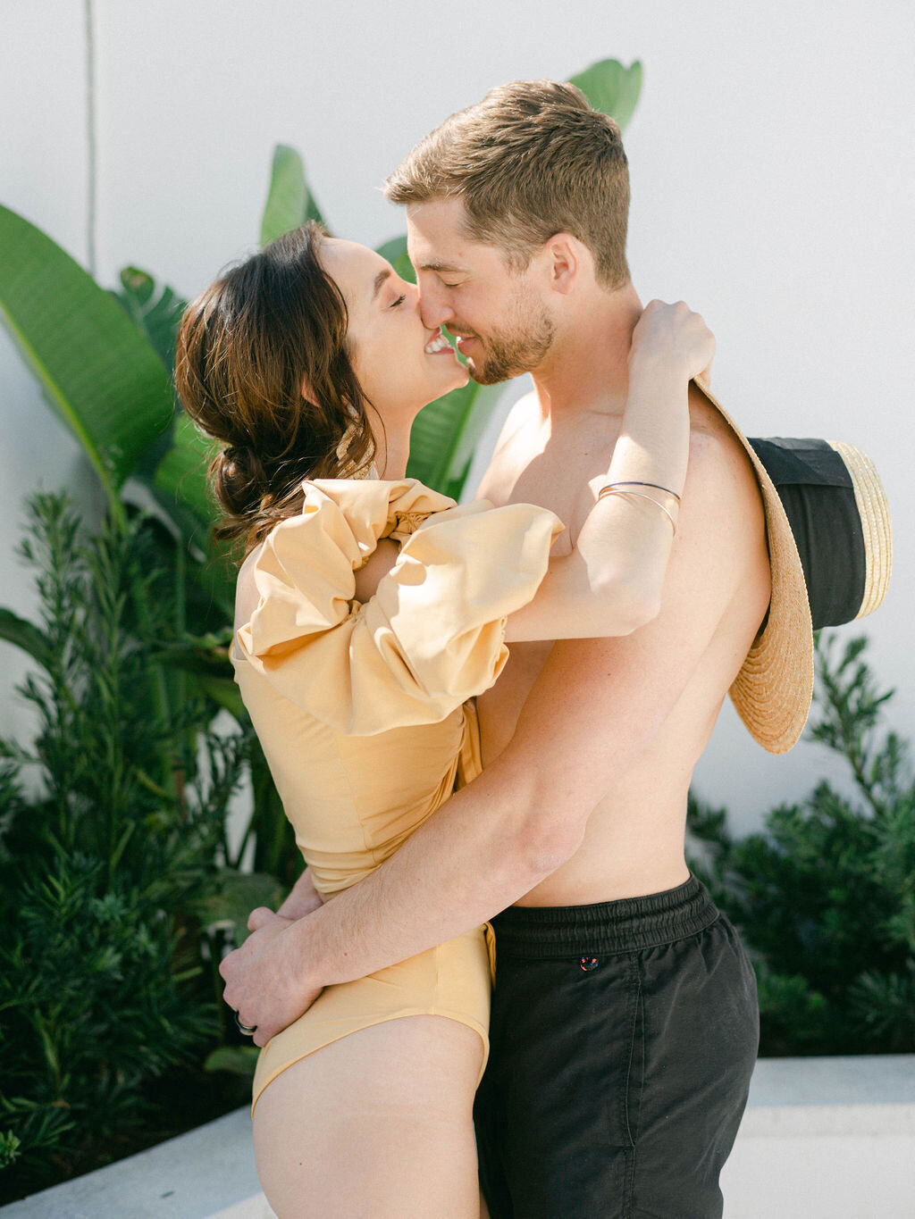 couple kissing on honeymoon at Honeymoon at Kaiya Beach Resort in Seacrest Florida
