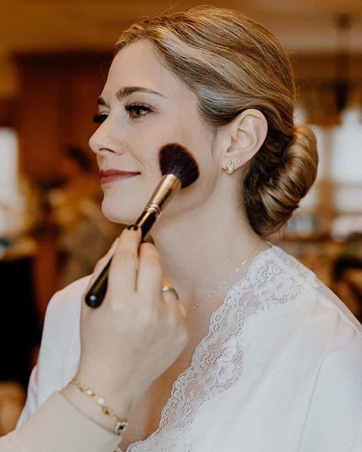 bride getting blush put on her cheek