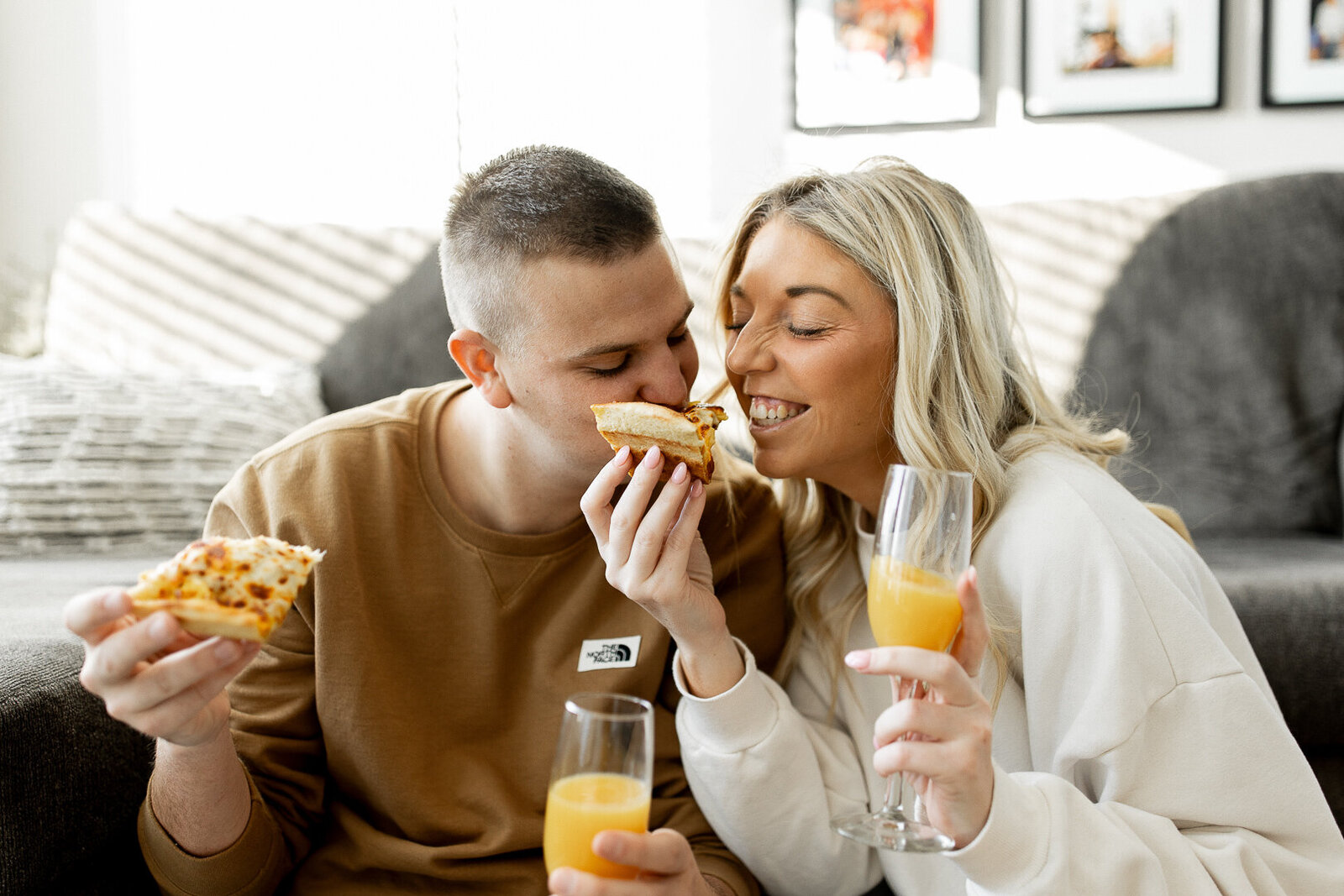 Waukee couple eating Casey's pizza together on their living room floor