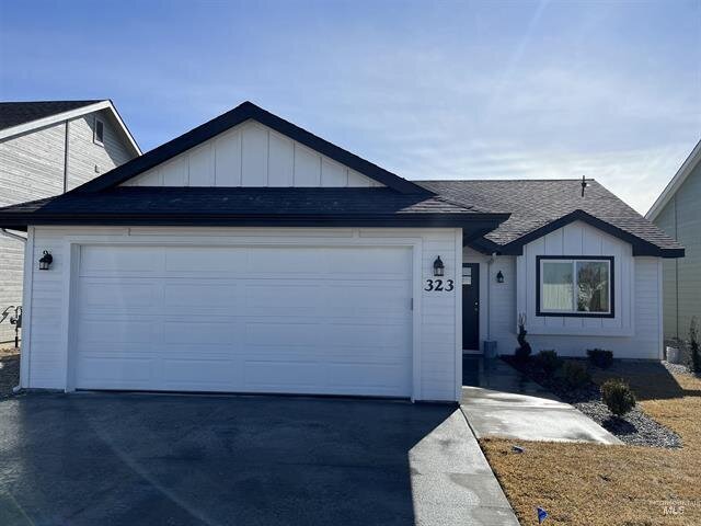 new home build painted white with black roof two car garage