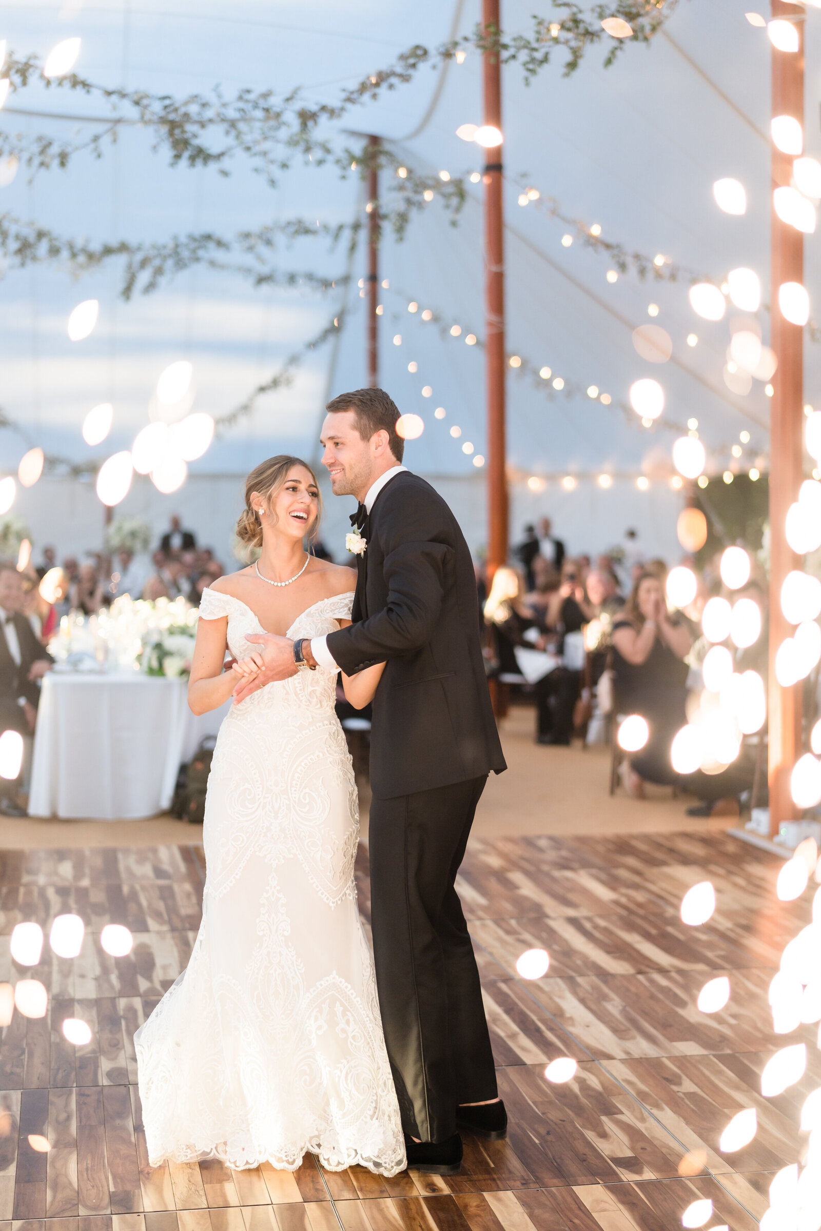Bride and groom share their first dance as sparklers erupt all around them