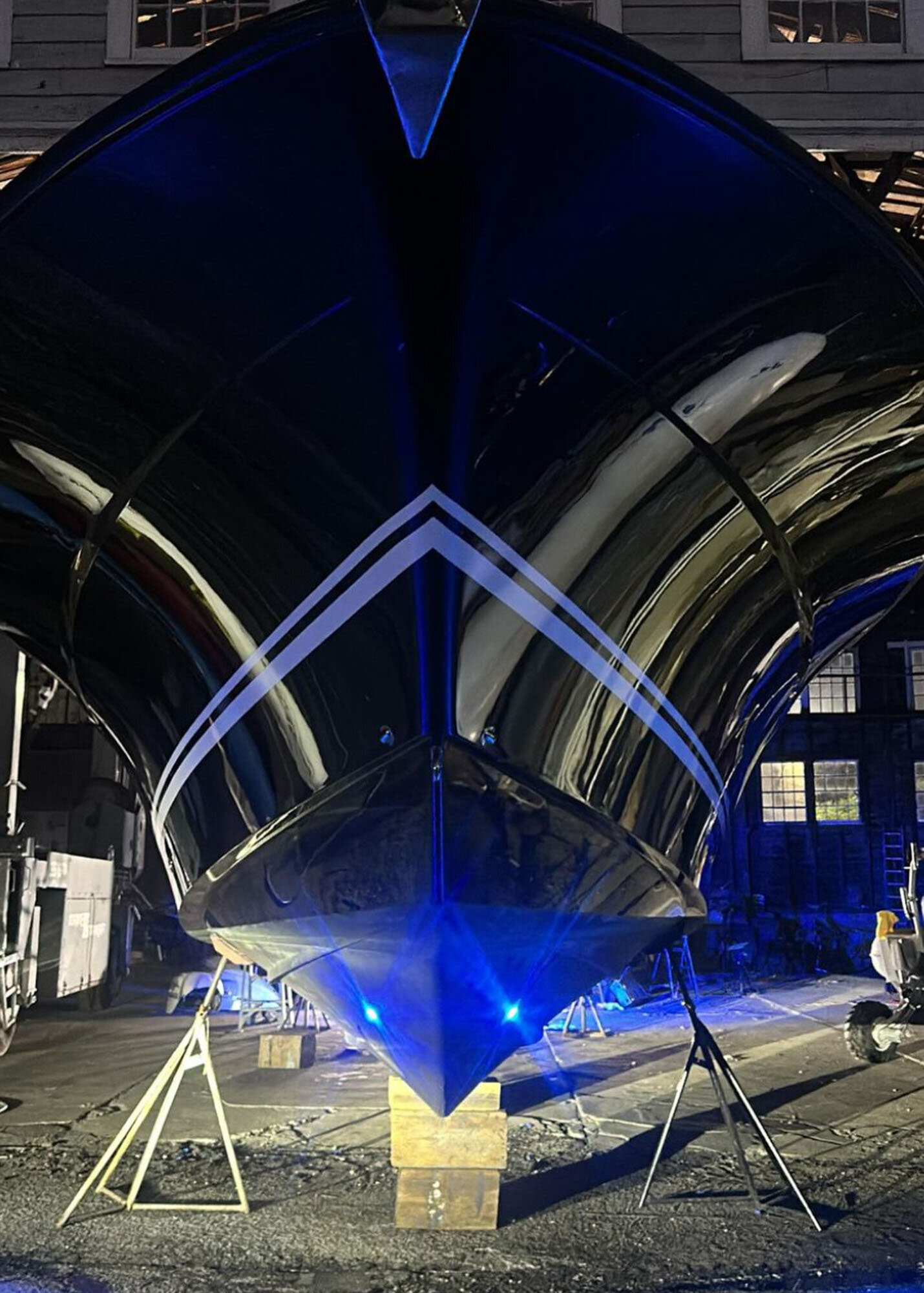 Front view of a yacht under detailed blue lighting