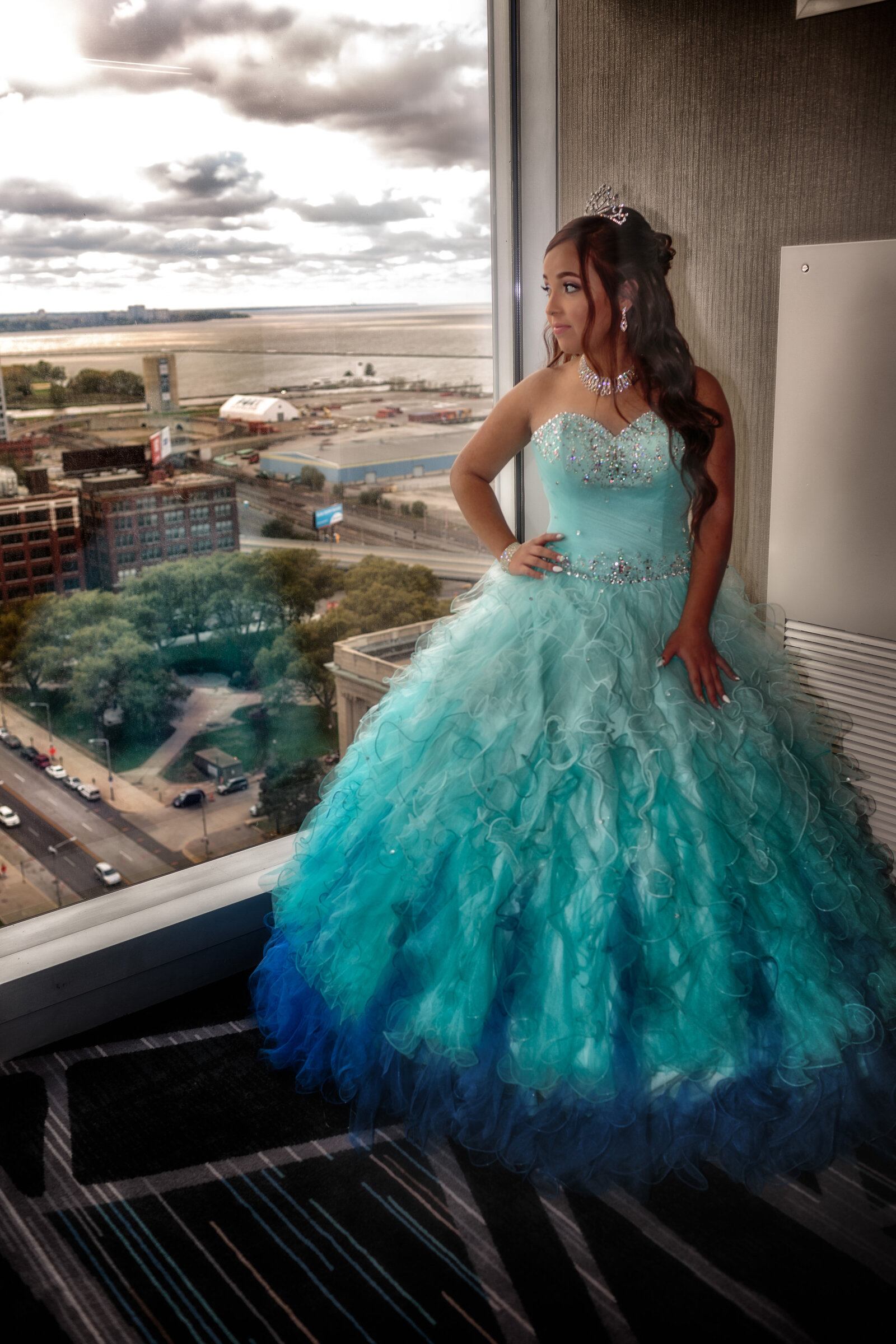 A stunning portrait of Yarelis in her quinceañera gown, posing in the sophisticated lobby of Hilton Cleveland Downtown. A perfect blend of elegance and modern architecture.