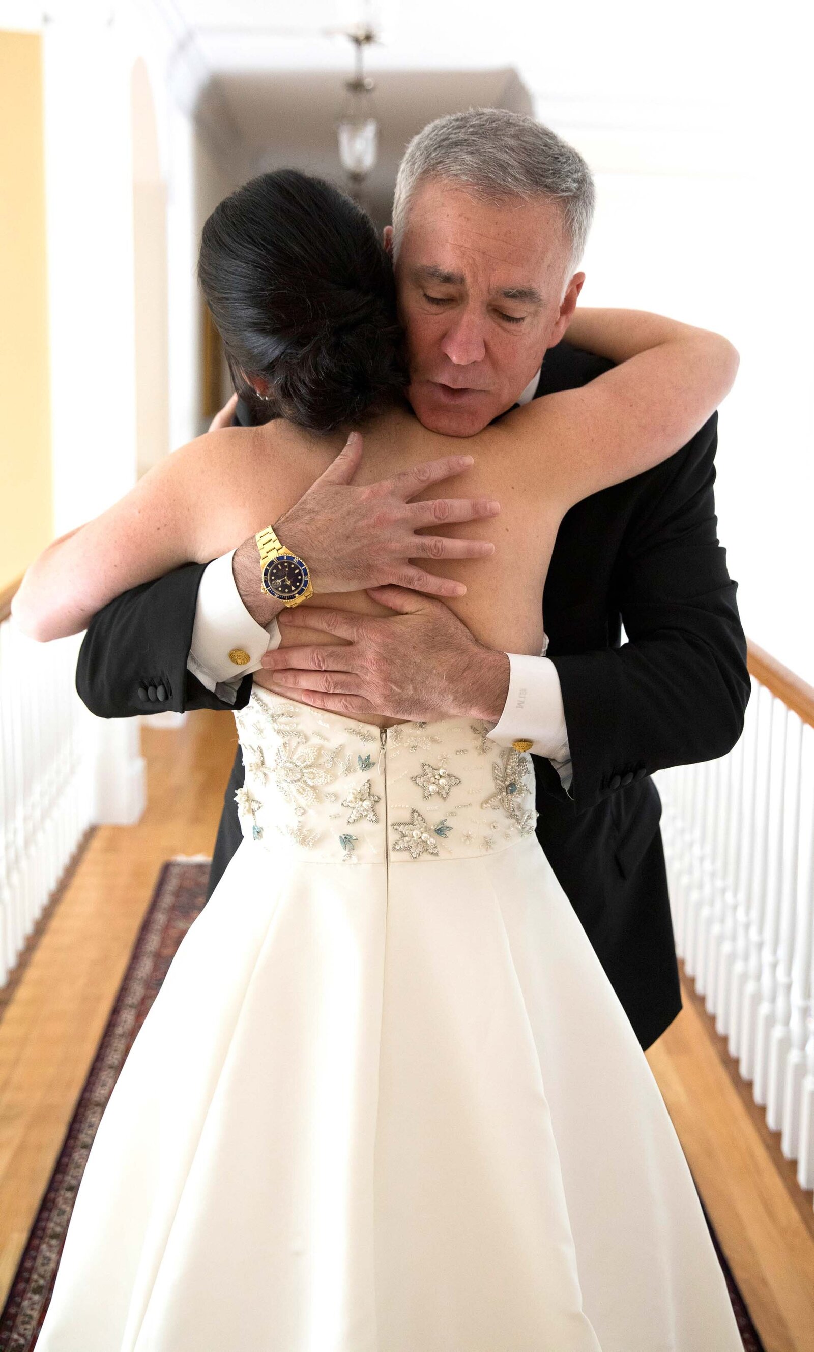 Father of the bride seeing his daughter for the first time, hugging her.  Father first look