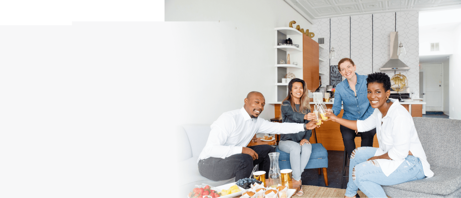 Group of people in the kitchen laughing together drinking mimosas in Washington DC