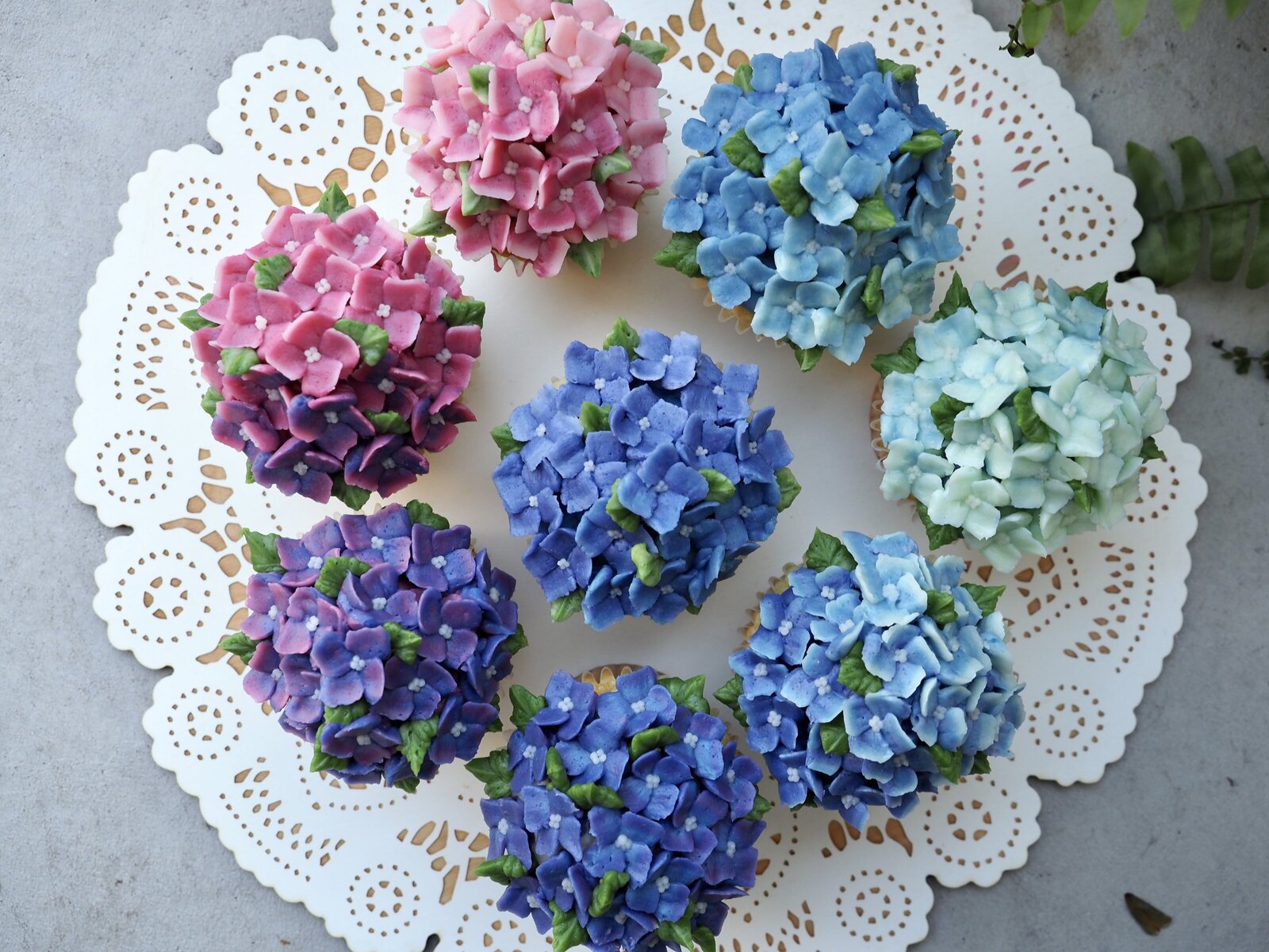 Hydrangea cupcakes piped out of buttercream on a tray