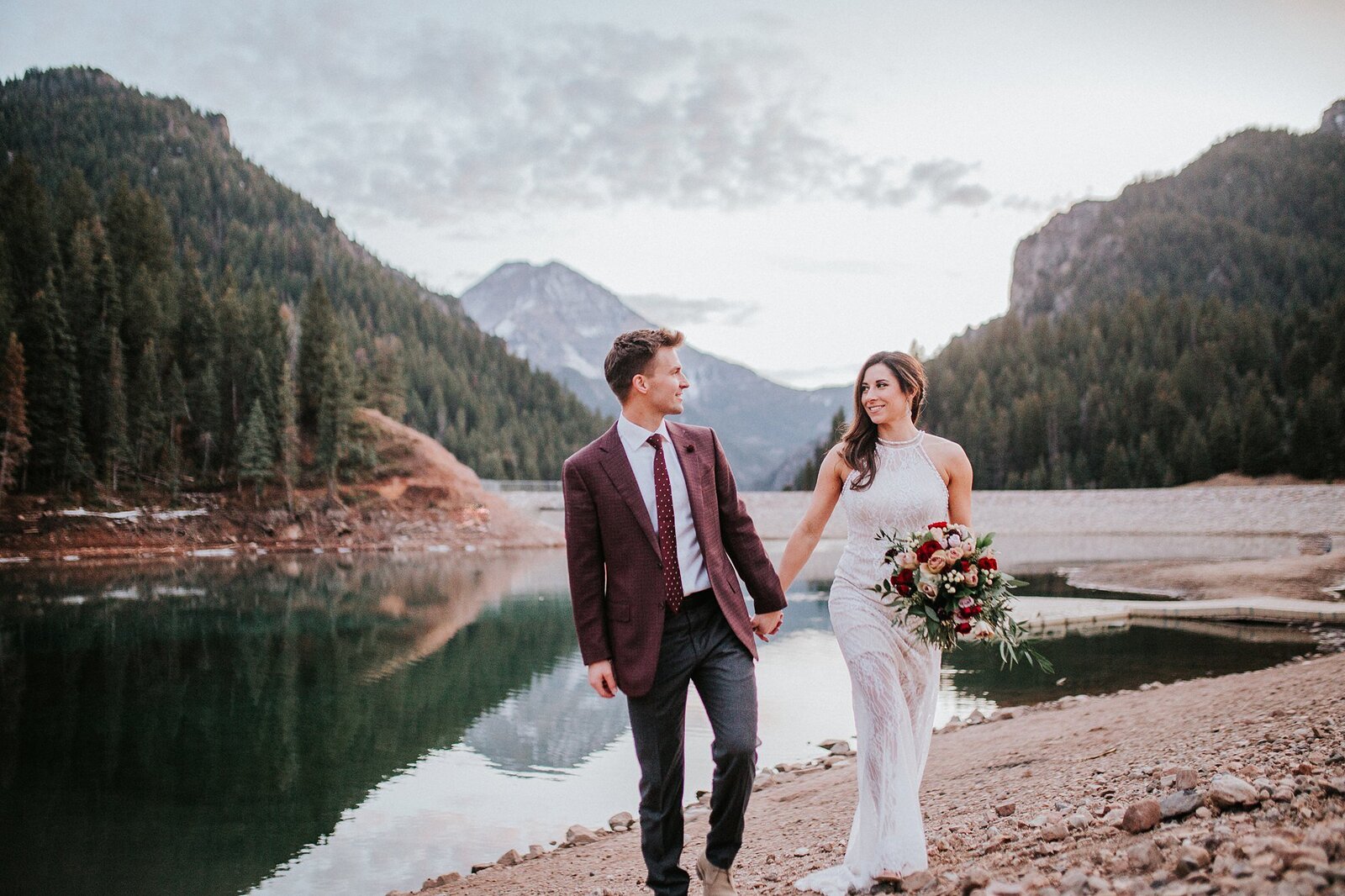 Sacramento Wedding Photographer captures bride and groom holding hands while walking lakeside