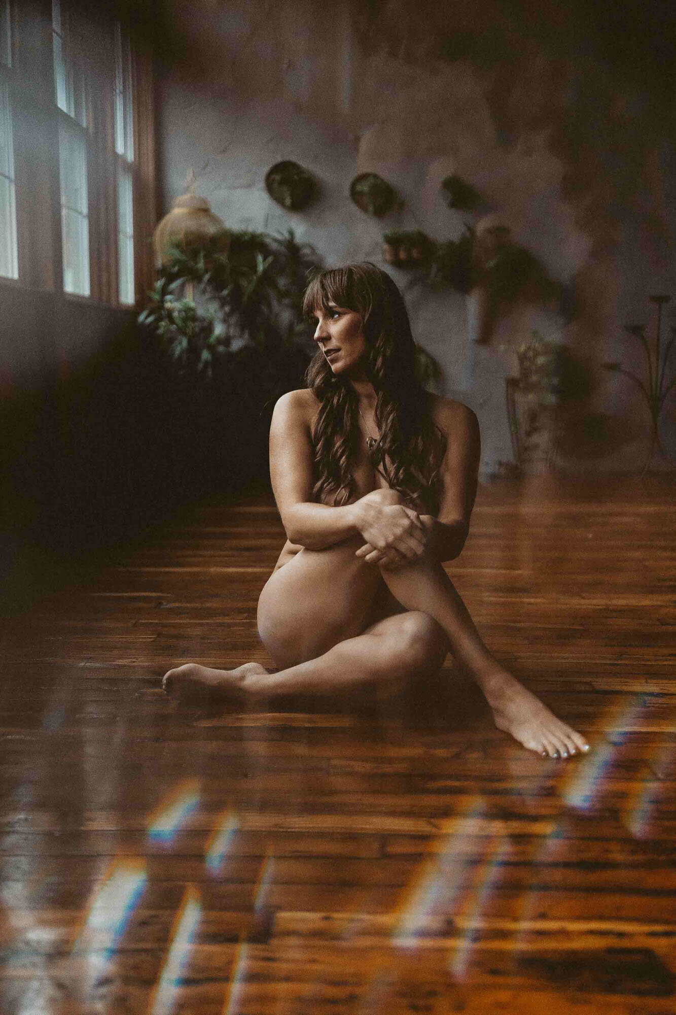 woman sitting on the floor while crossing her legs