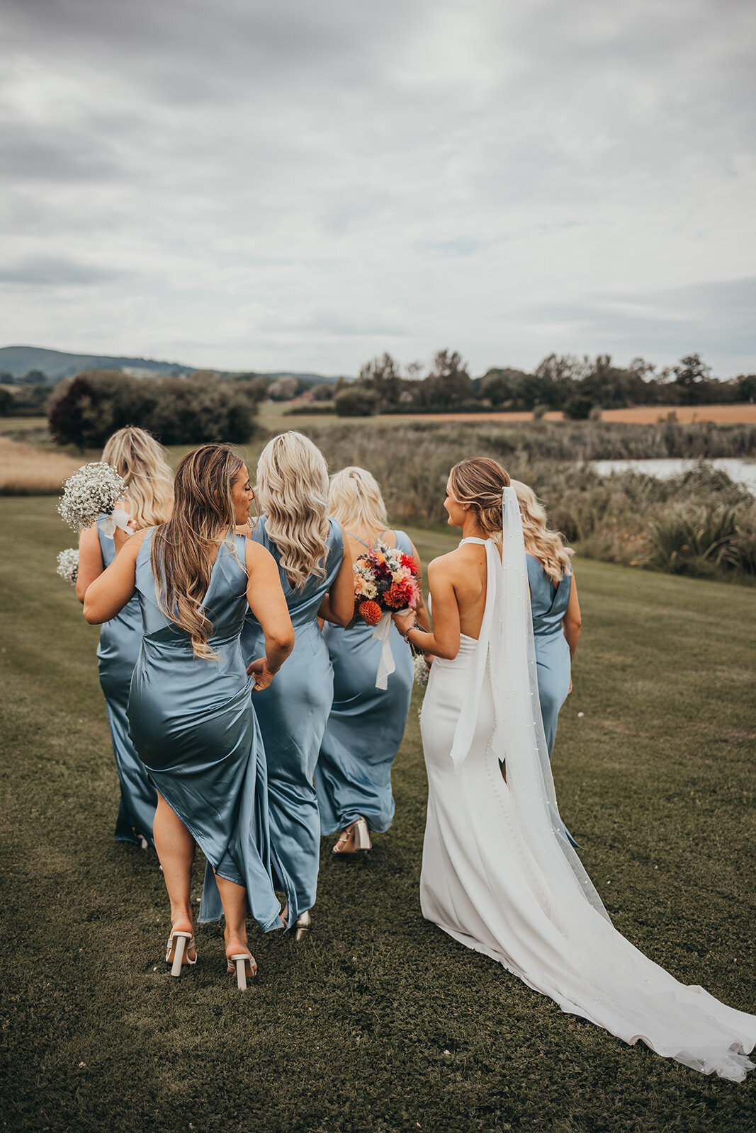 bride and bridesmaids walk together