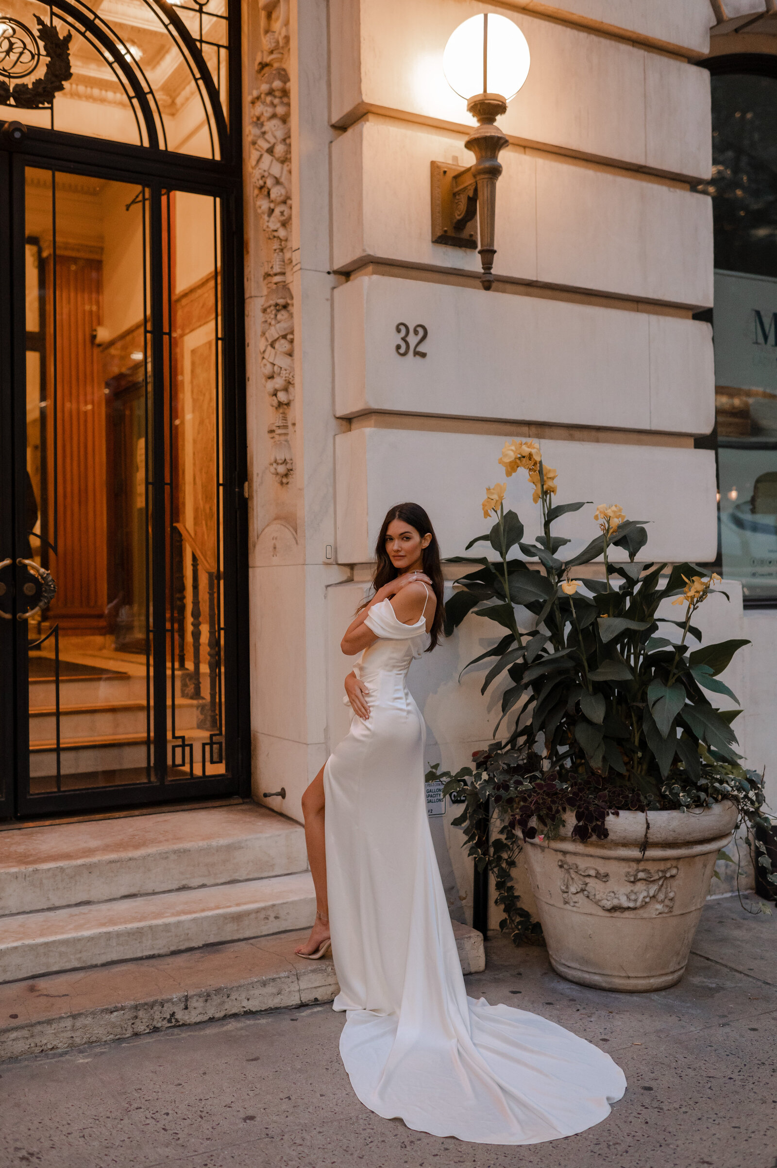 bride wearing white satin wedding dress with long train