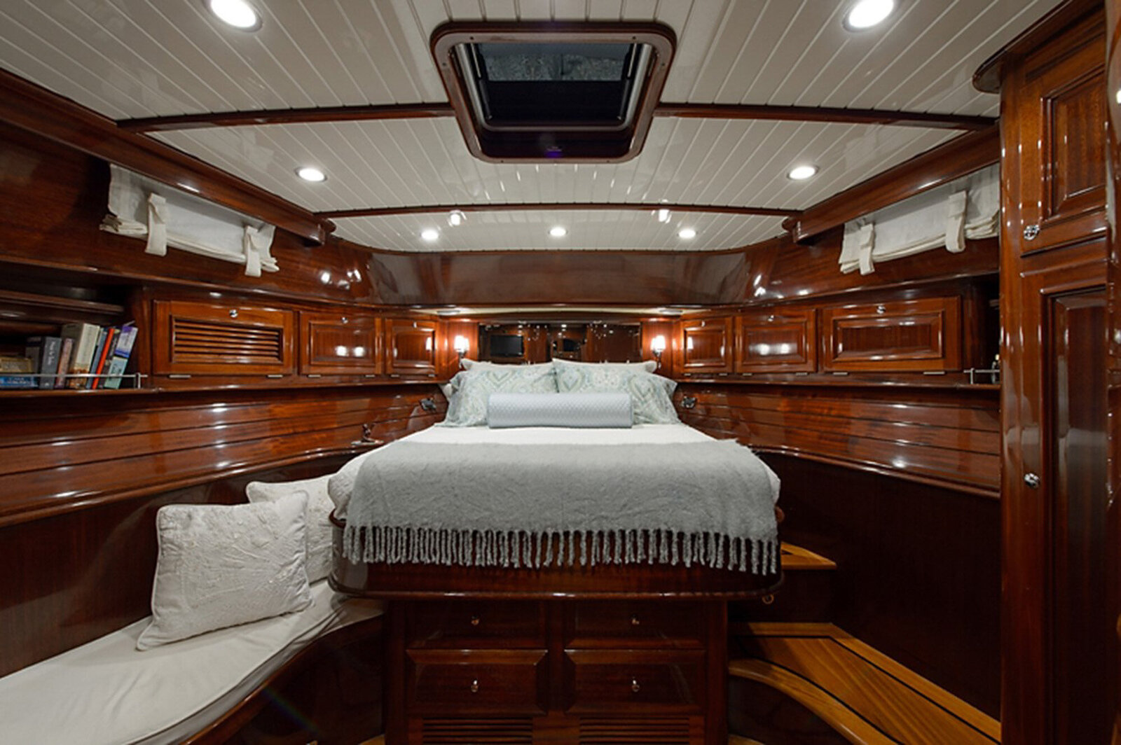 cozy yacht cabin featuring polished wooden walls and ceiling