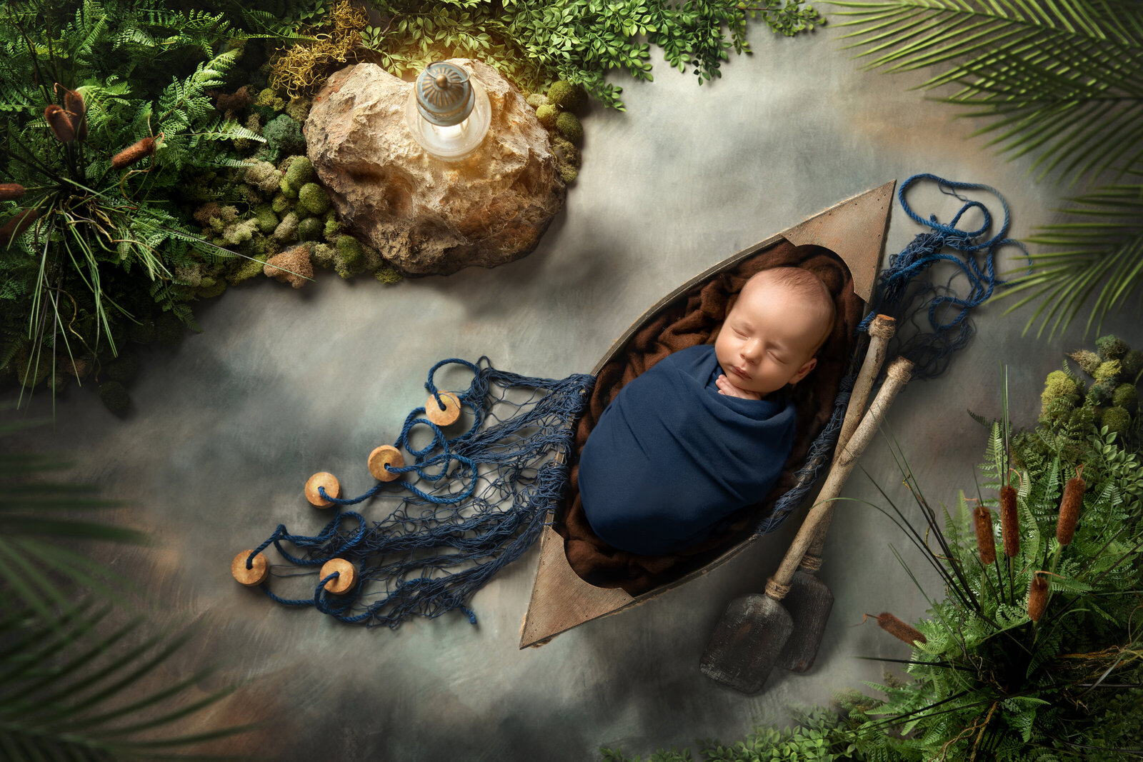 baby in a boat for newborn photography