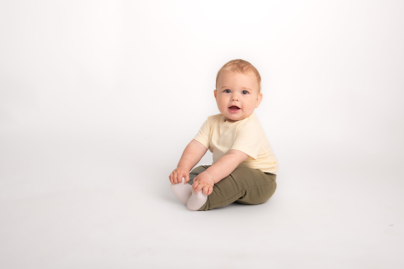 baby boy sitting on floor for modern school indoor pictures