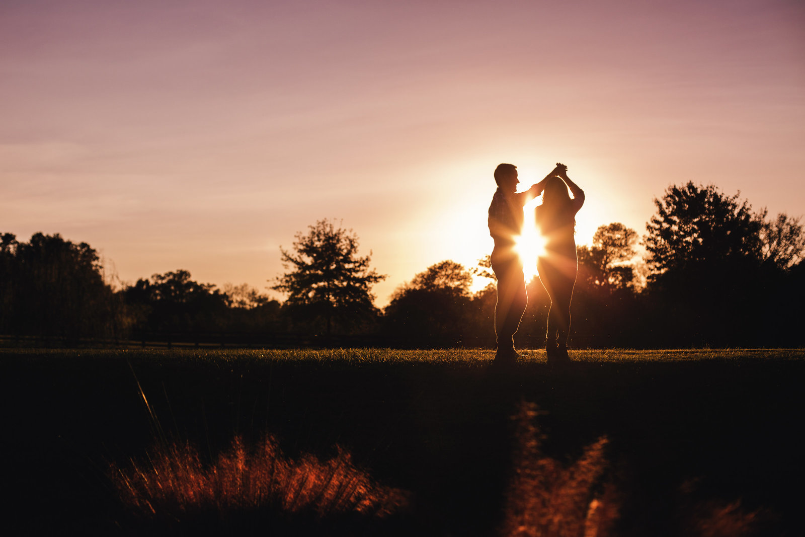 mother walks hand in hand with daughter and holds small child at Myrtle Beach beautiful moment with family photographer jamie lucido