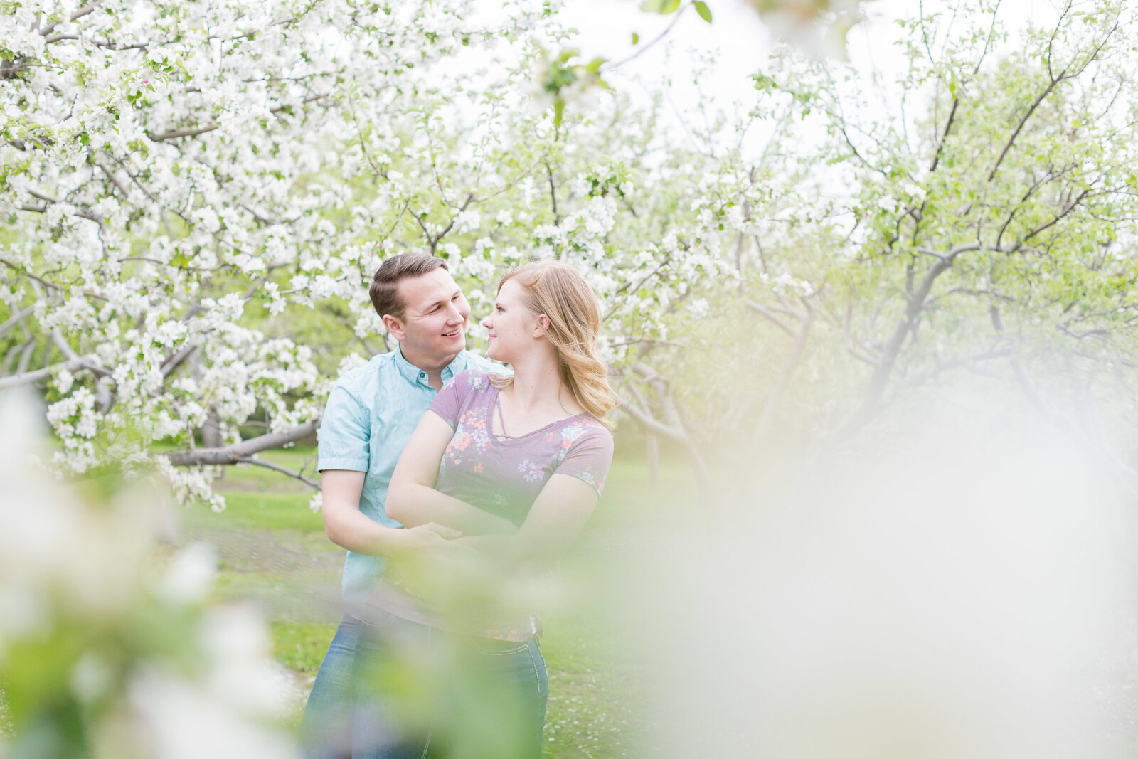 Seattle Wedding Photographer captures couple dancing in a field of blossom trees