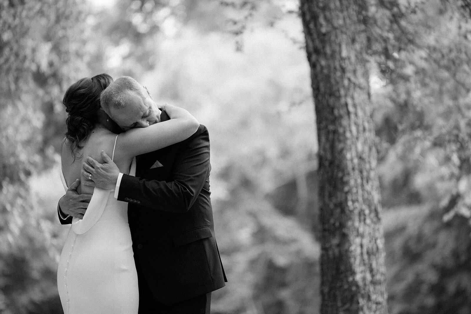 Father embraces his daughter emotionally during their first look along the river in Tennessee.