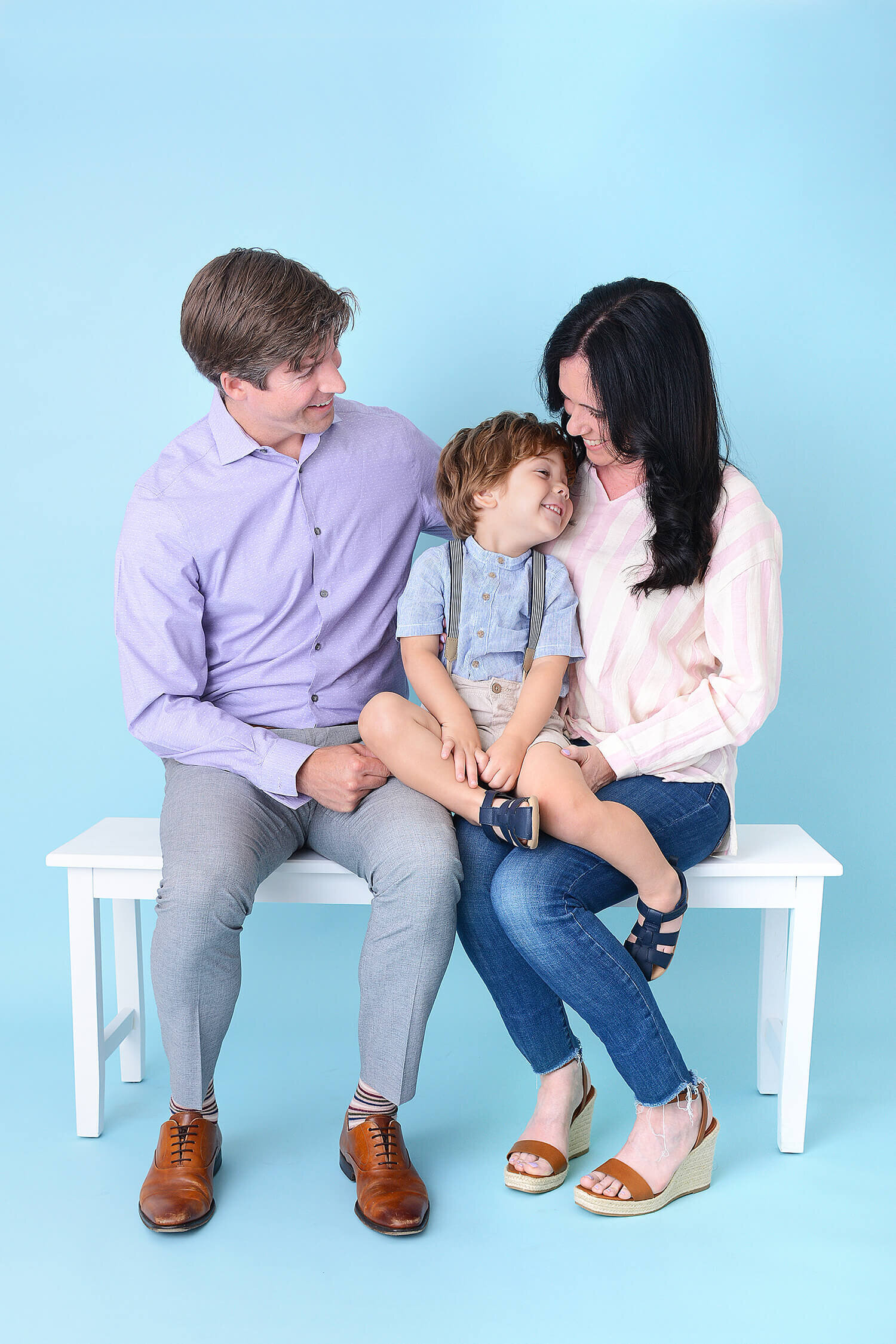 family cuddles up at their photo session in houston