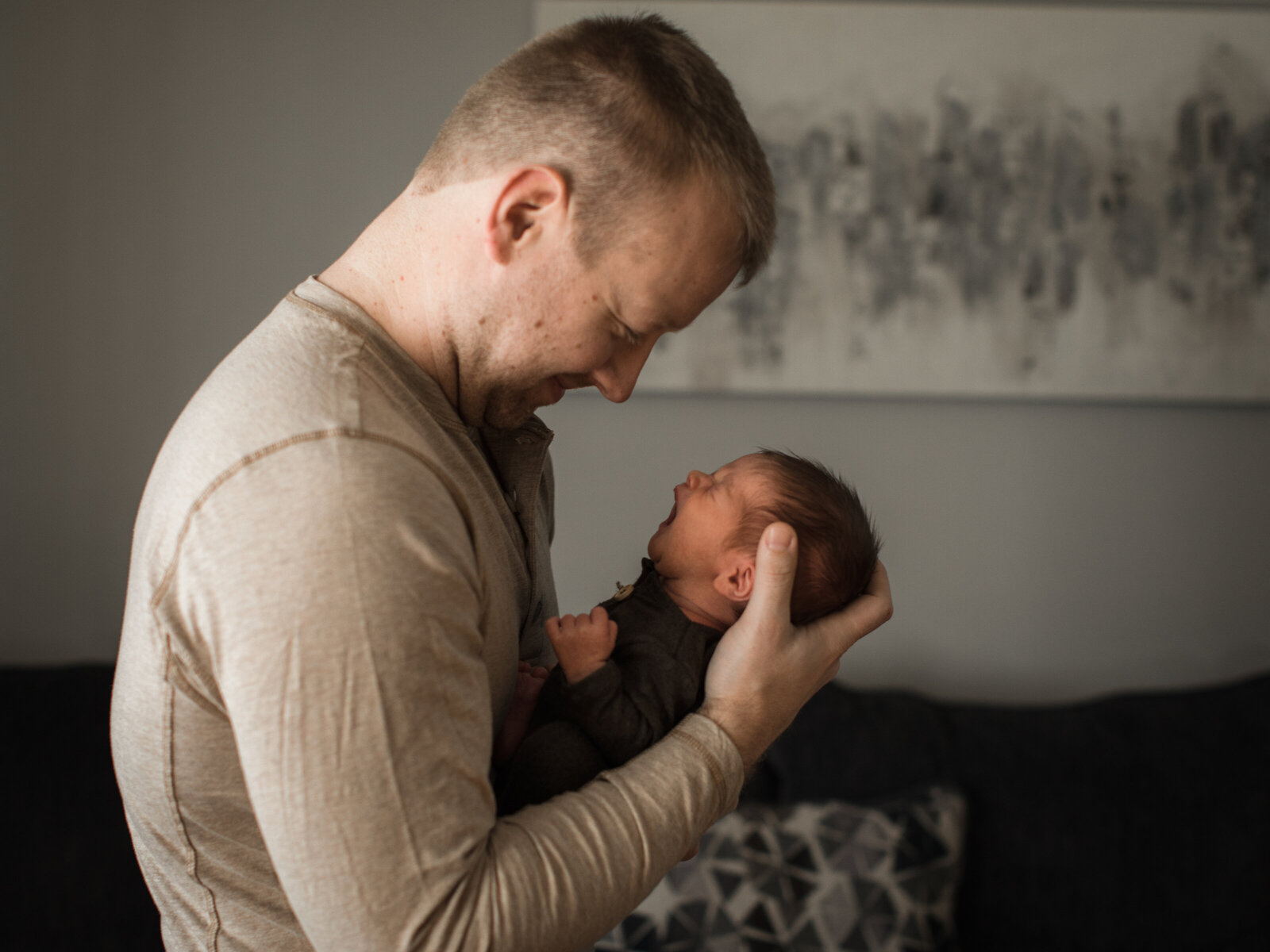 dad holding newborn son for in home lifestyle session