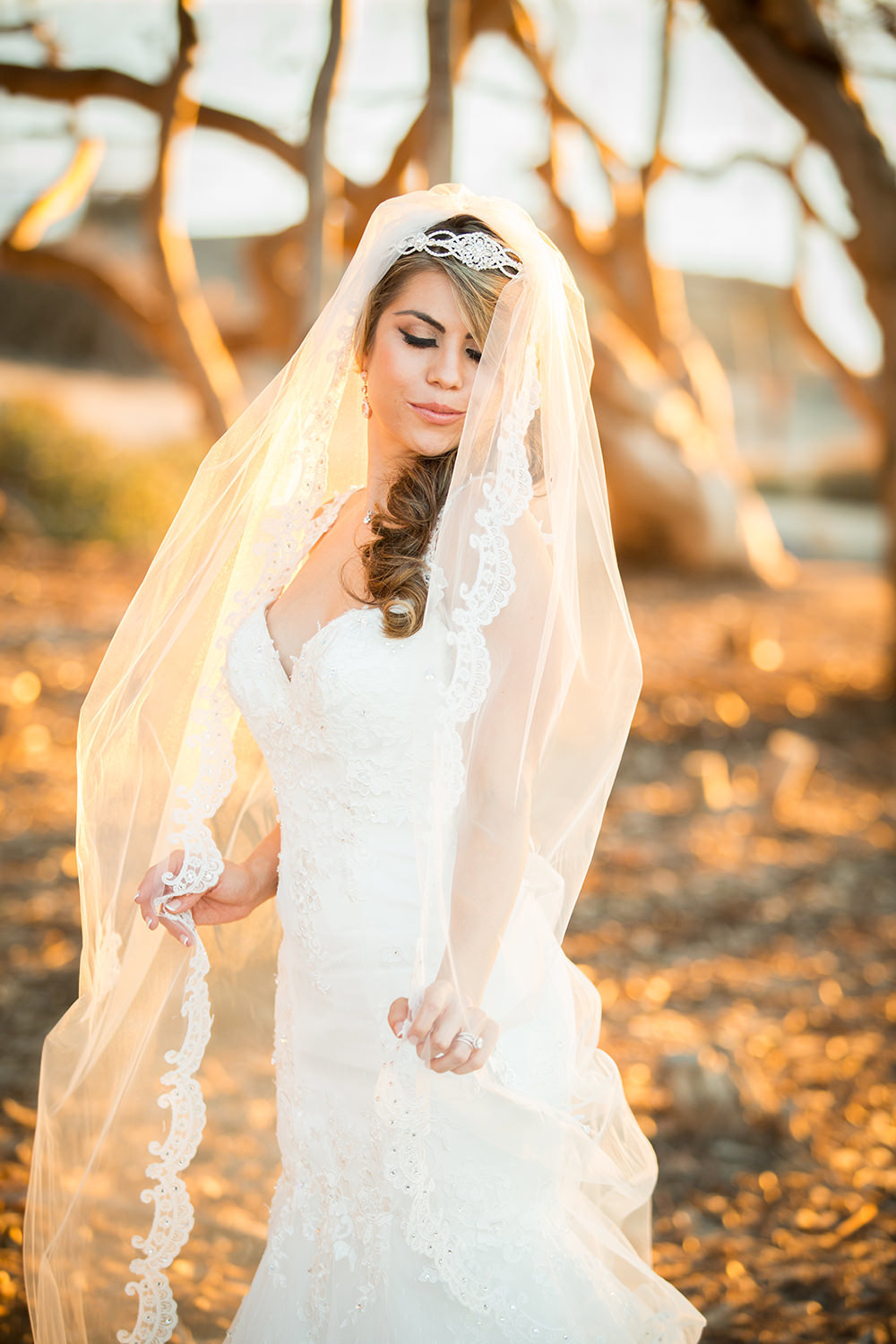bride with long veil at sunset cliffs