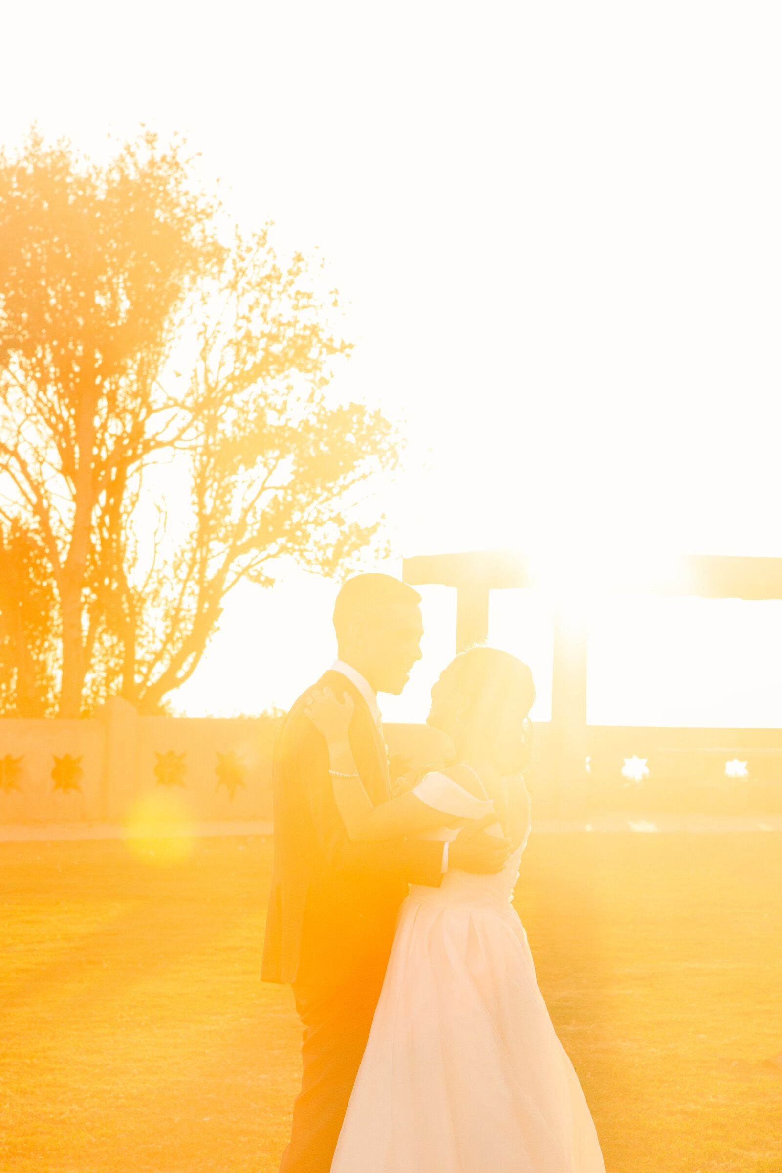 Newlyweds share their fist dance at their beach wedding in Los Angeles at sunset.