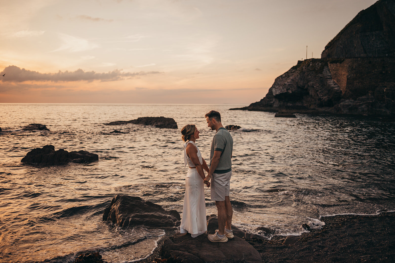 couple hold hands on beach