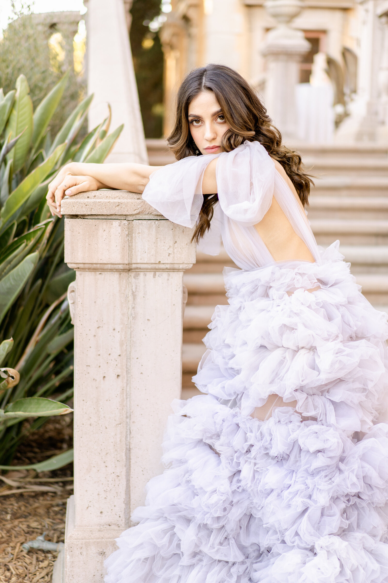 Portrait of bride in a lavender gown in front of concrete steps outdoors