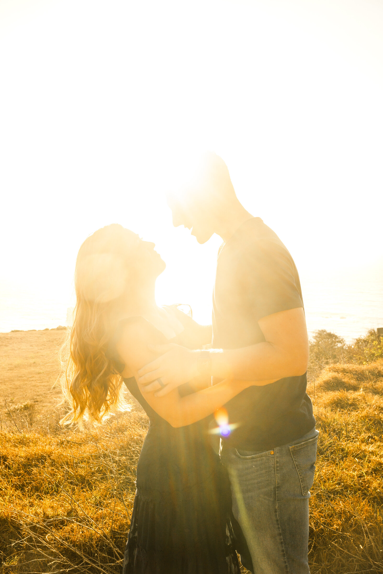 A couple poses for their engagement photos in Big Sur, California.