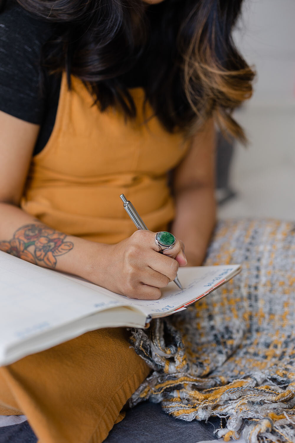 woman writing on a notebook during branding pictures in Ashburn,Virginia