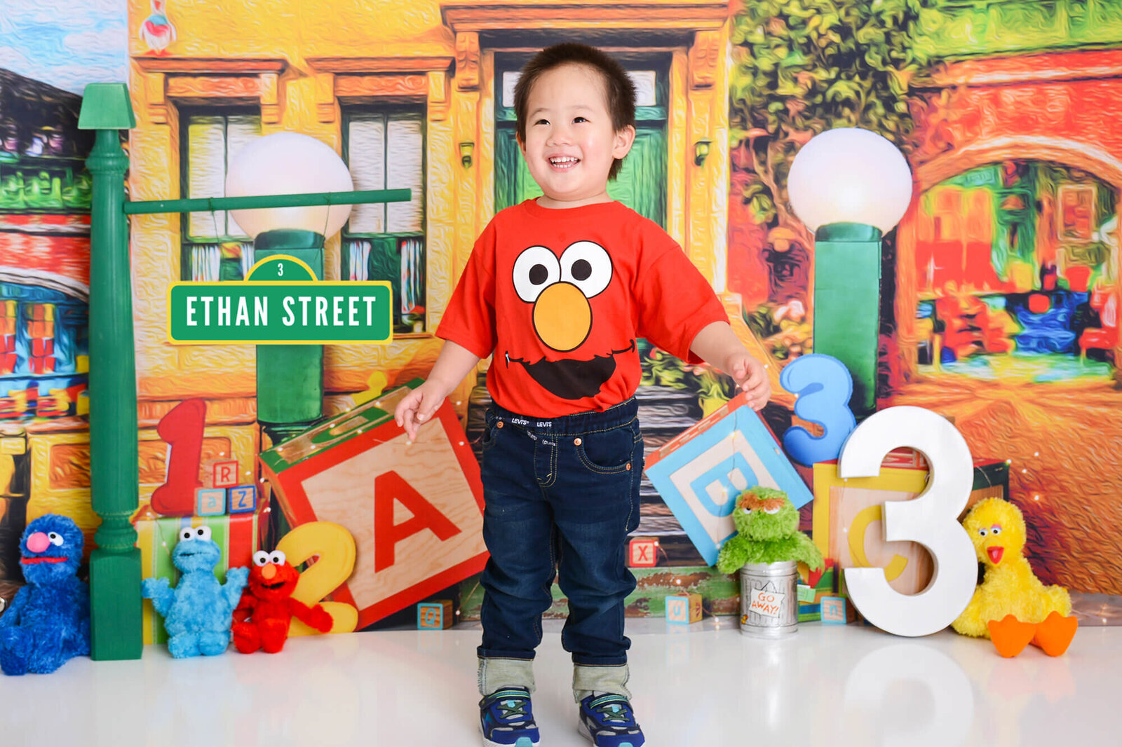 boy wears an elmo shirt at his sesame street themed shoot