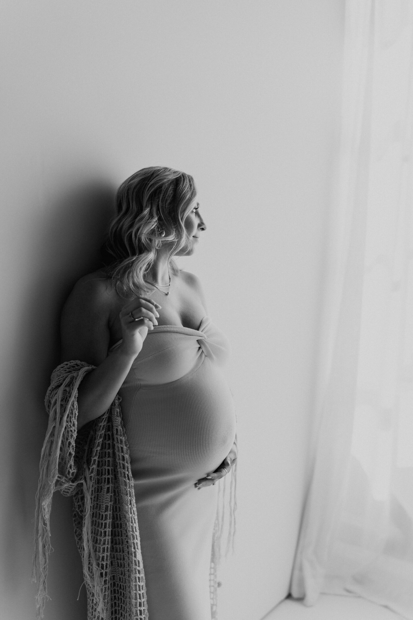 classy black and white maternity picture mom looking out window