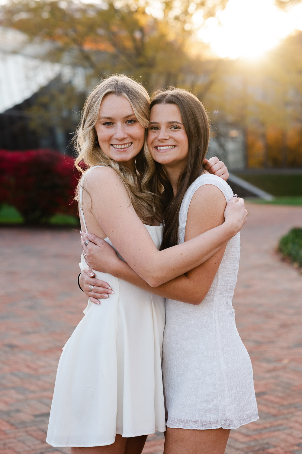 grad portrait friends hug in sunlight