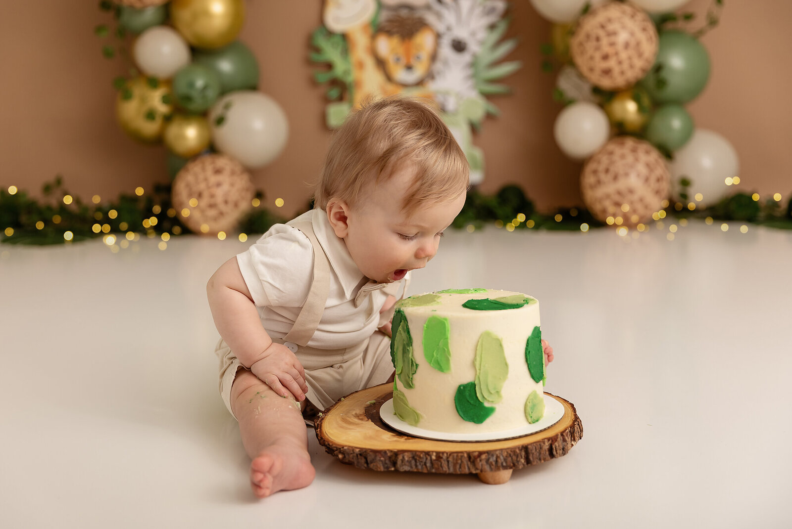 baby about to eat cake in birthday photos by milestone photographer new philadelphia