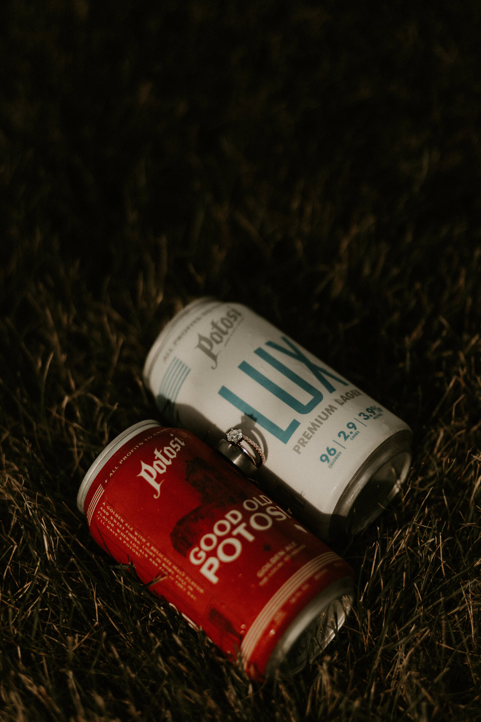 rings placed in between two Potosi beer cans at backyard wedding in Wisconsin