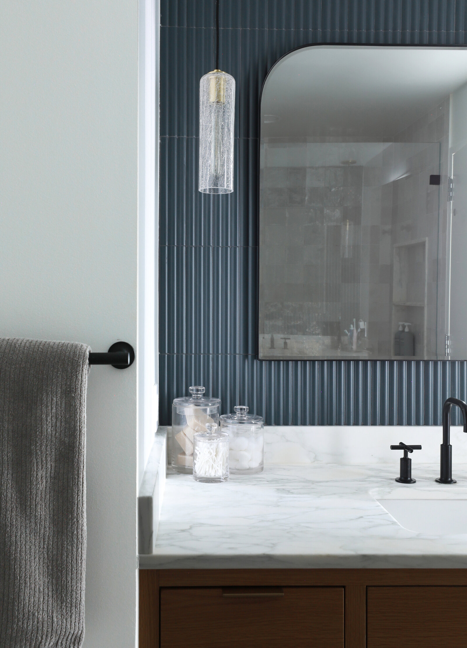 PRIMARY BATH WITH HANGING PENDANTS CUSTOM VANITY AND TEXTURED TILE