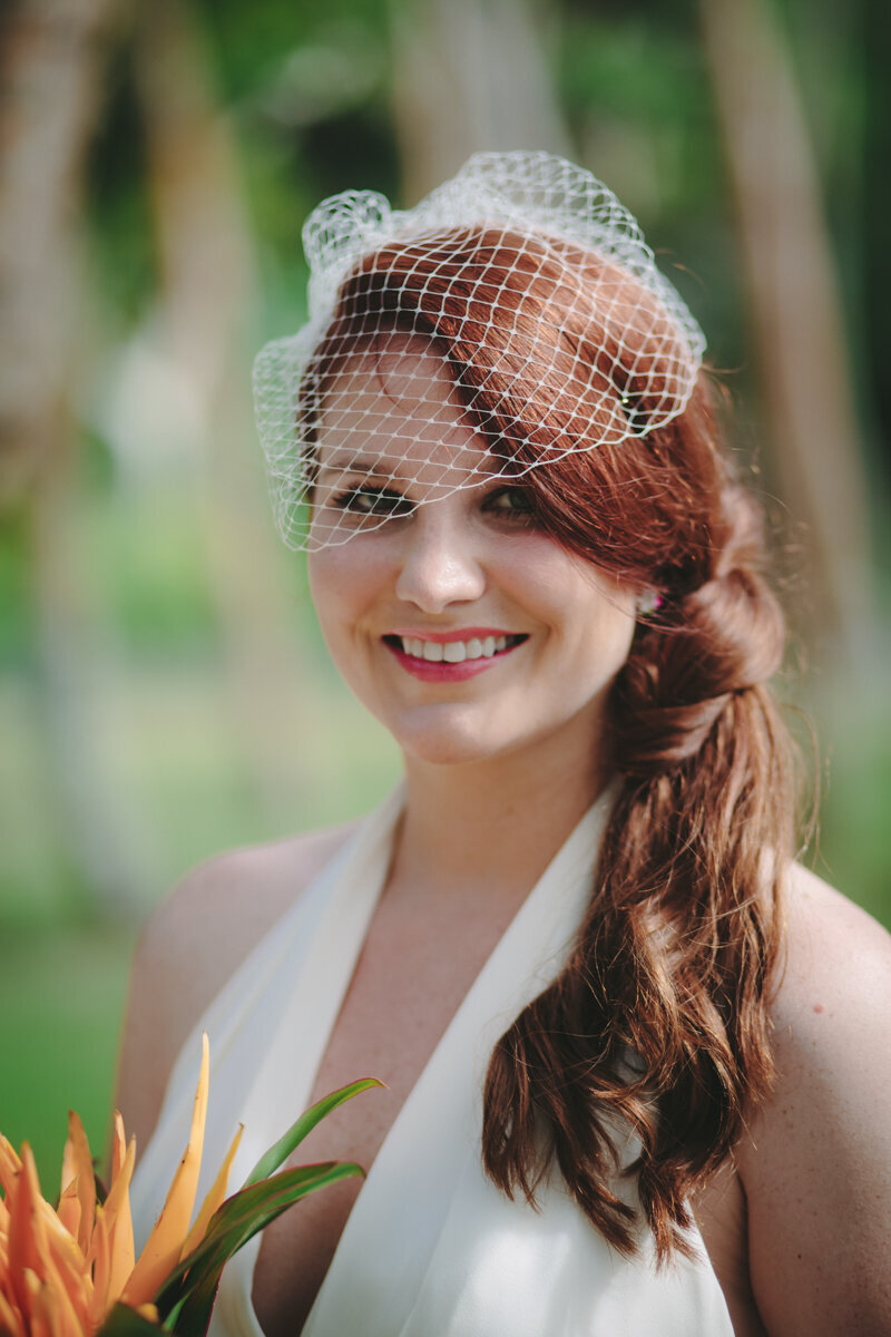 Bride with a beautiful fascinator in her red hair