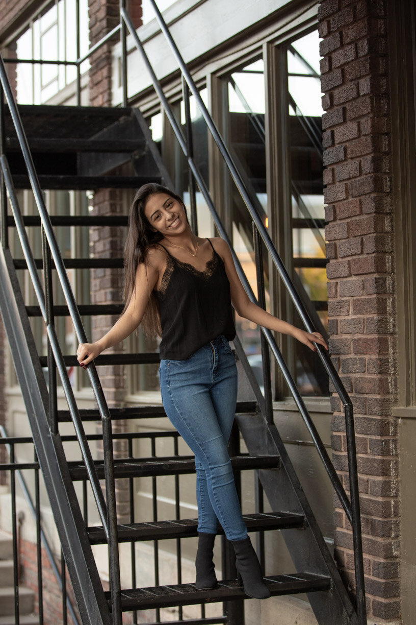 GAbrielle poses on a fire escape in the Haymarket during a senior photo session