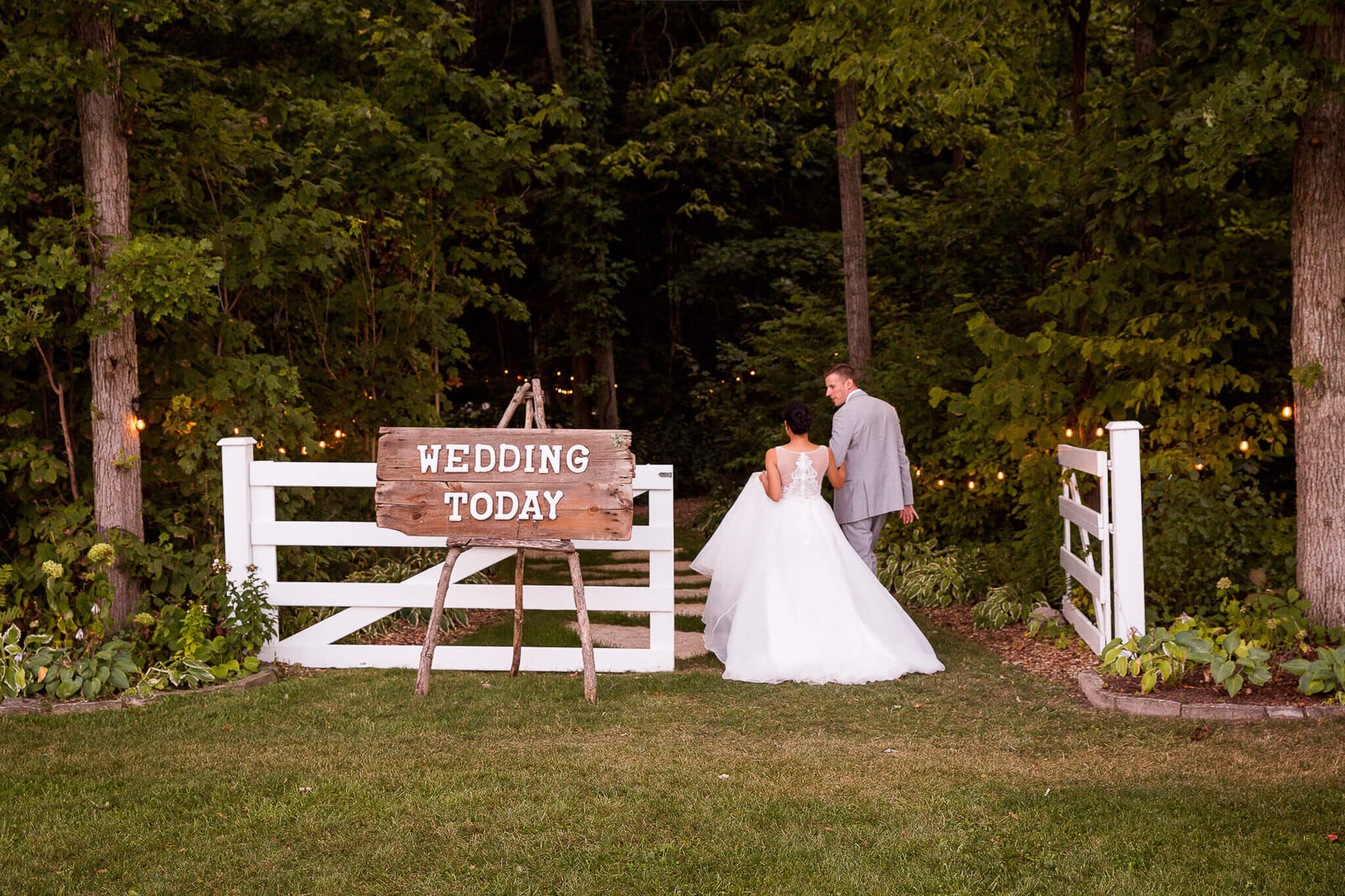 Bride and groom walking together with wedding today sign.