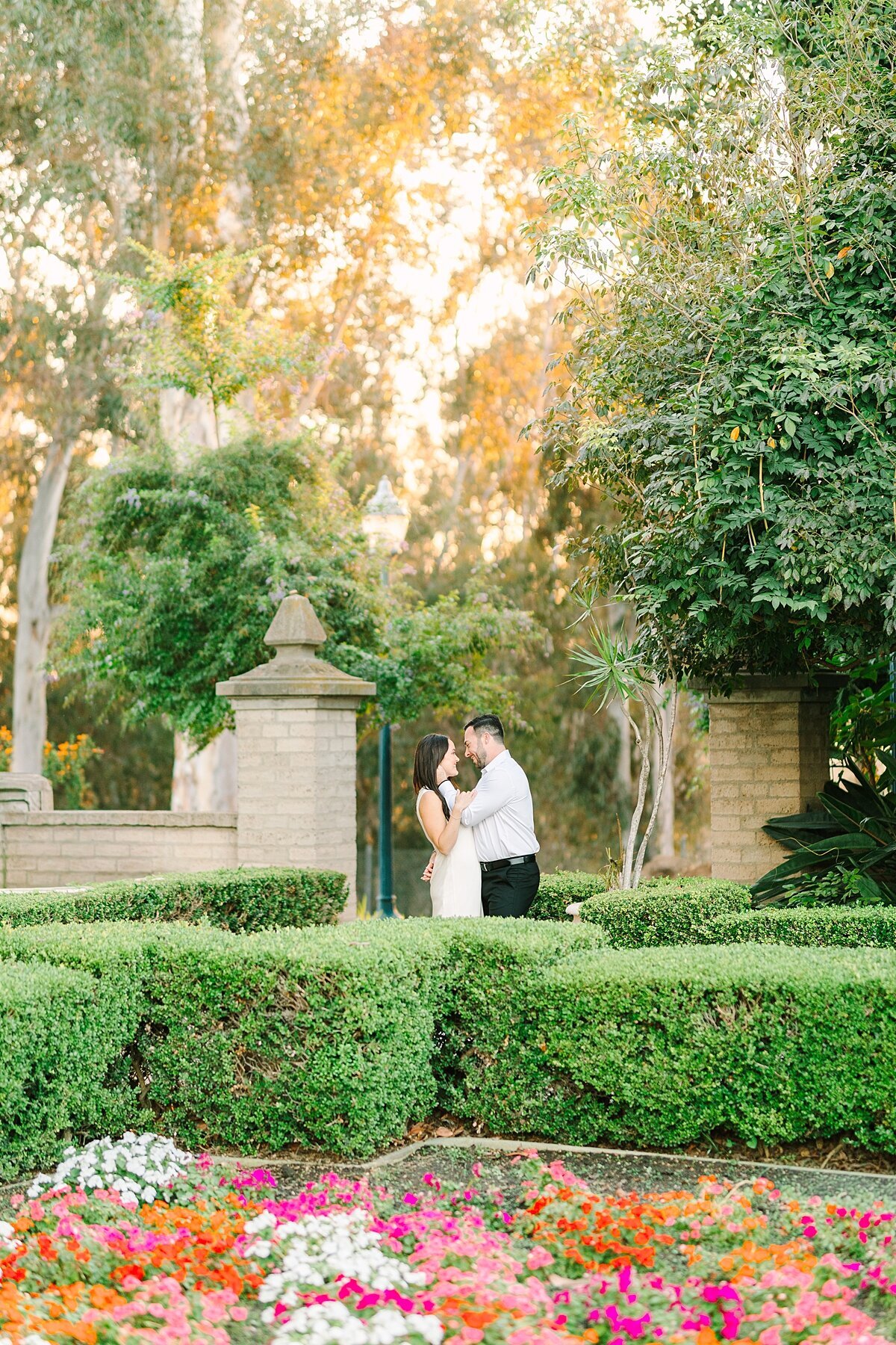 Bride and groom kissing in Alcazar Gardens in Balboa Park during sunset.